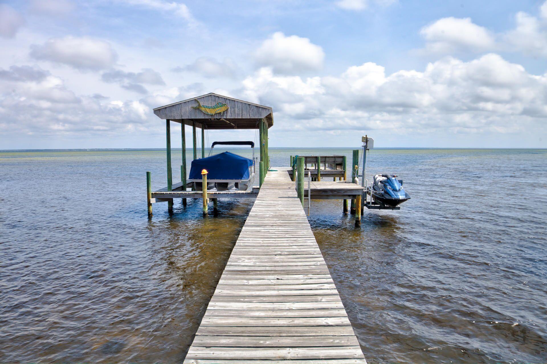 Water front living at its best! Located in Miramar Beach and close to the Gulf of Mexico, with all of the restaurants and shopping outlets; this is the one. Literally only a few miles from the Silver Sands Factory Outlet and only a mile from the beach and the beach front bike path. Location, location, location! Built in 2004, this bay front home was built from cement block and located on an over sized lot with 101' of bay front. The elevation is 10'8'', well above the standard requirements. This home has the most incredible water views from just about every room! The dock and covered boathouse is complete with boat lift and jet ski lifts. This is a great home to grow your family or an incredible house for entertaining. WATCH THE VIRTUAL TOUR!
