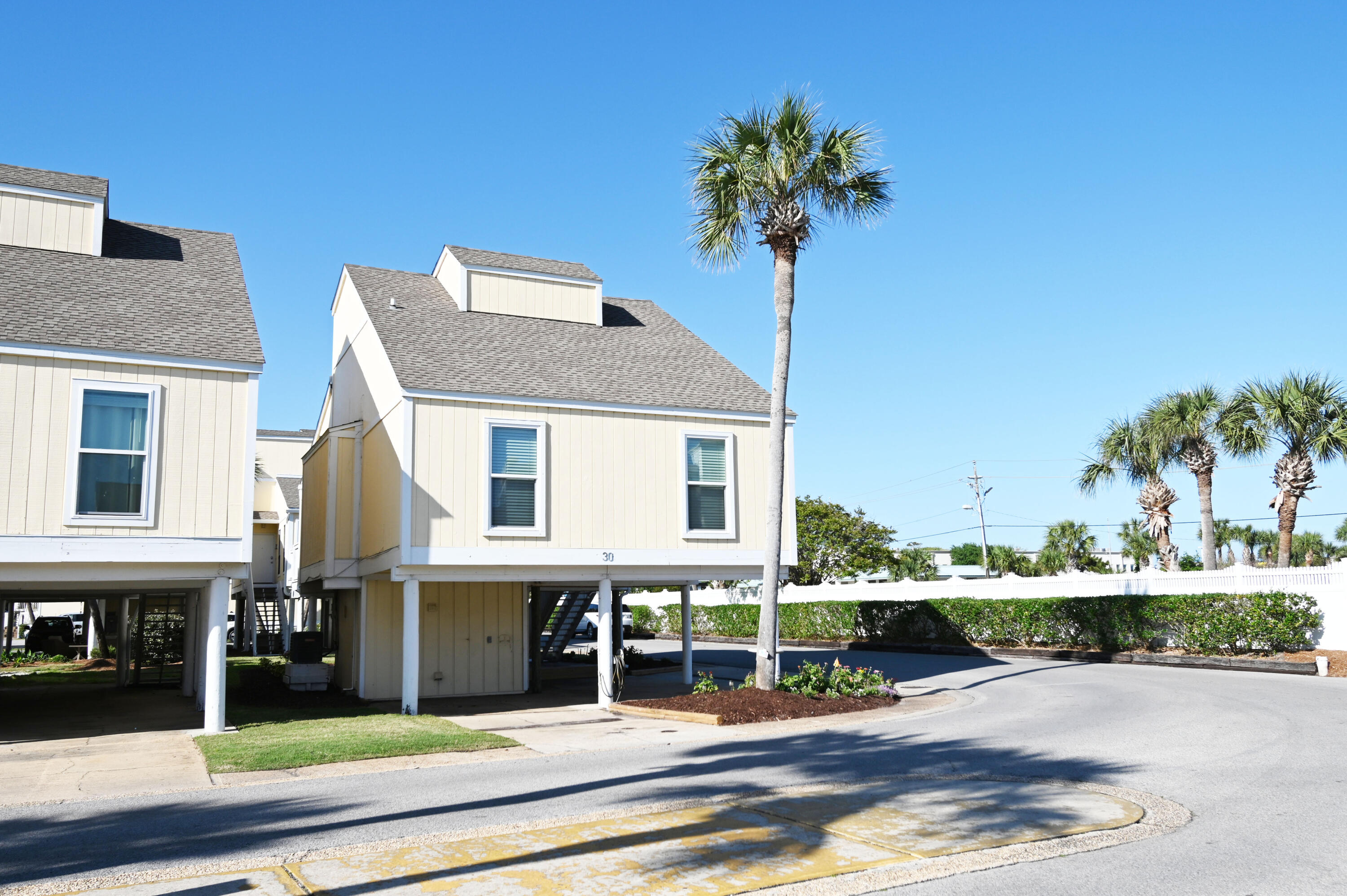 Major Price Reduction and ready to sell!Welcome Home! This retro, fun Sandpiper Cove townhome is waiting for you. The only one of its kind for sale right now. So bring all of your toys because it has plenty of parking for a boat, truck, golf cart, and more! It sits on a beautiful corner lot with lots of grass and a nice garden area. It has a new roof, windows, and doors. Brand new $3400 refrigerator that has never been used.Take a very easy walk across the street to the 1100 feet of pristine deeded private beach and the famous Rick's Sand Trap. Sandpiper has so many amenities like an owners marina, boat launch, canal boat parking for rent, tennis and pickle ball courts, 5 pools, 2 which are heated and three hot tubs which is unlike any other condo.