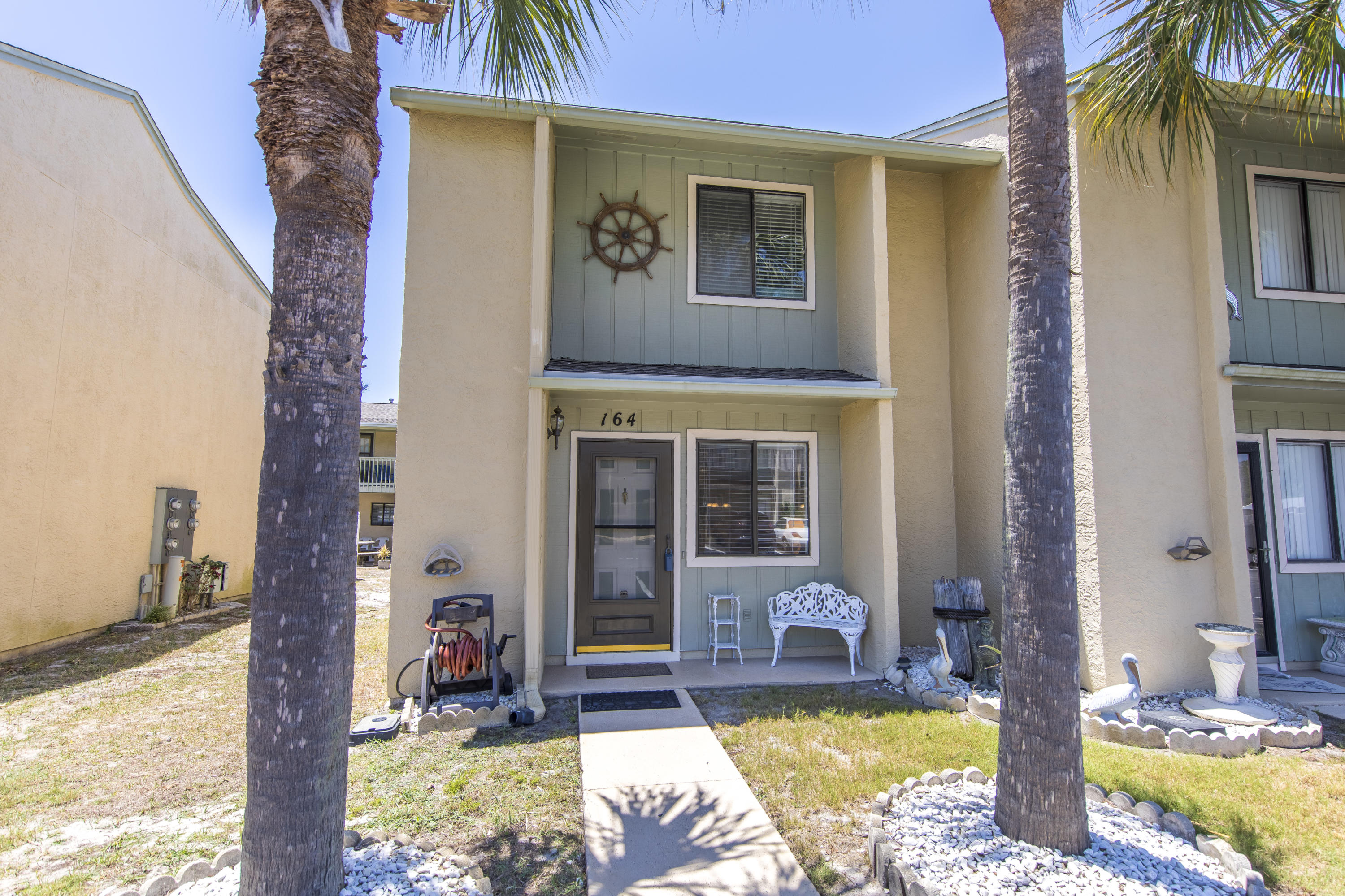 Hidden gem located a short walk to the Gulf of Mexico and right across the street from the community pool. This would be a perfect primary residence, second home, or rental investment property for a new owner. Boasting two (2) bedrooms, and two (2) and one half bathrooms, this home is perfectly designed. This is a corner townhome with only one adjoining neighbor, and a beautiful private porch on the back of the home. The owners have taken great care of this property with many upgrades such as tile floors downstairs, refinished kitchen cabinets, hardwood floors upstairs, and stainless steel appliances. The HVAC system is brand new (inside and out). The furnishings in this townhome are premium as well, and great care has been taken to keep this townhome in amazing shape.