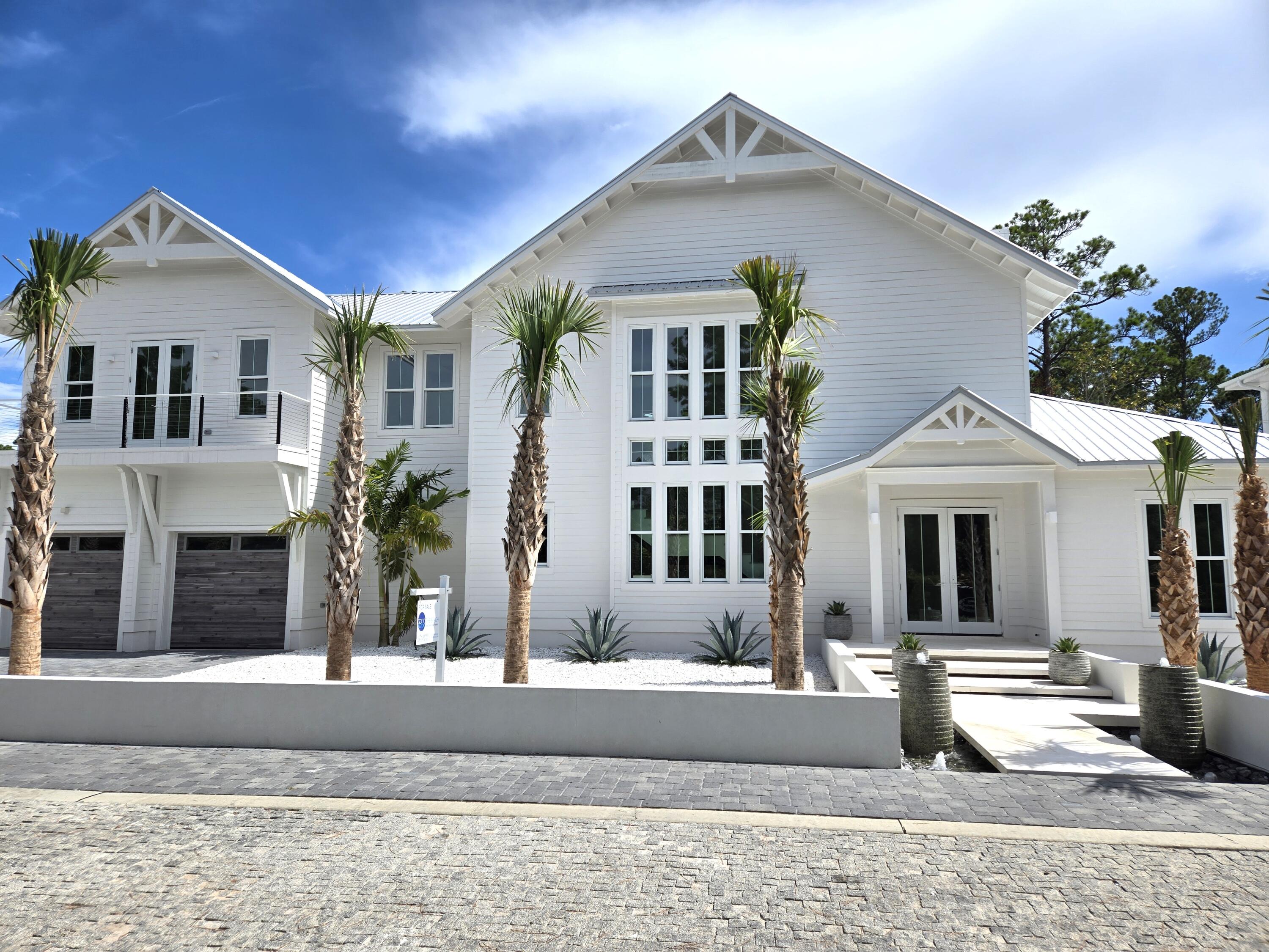 Introducing Saltwater, an exclusive luxury living development located in the corridor of historic Old Seagrove Beach. One of 5 bespoke homes to be released, 50 Saltwater offers a fresh look at coastal modern architecture. The home makes a statement even before entering, with its floating stairway, encompassed by a beautiful water feature with ambient lighting, leading to the front door. Exquisite white shell stone flooring carries from the floating stairs all the way through the first floor of the home, out to the back patio courtyard, allowing the indoors and outdoors to merge. The home's living space provides 22' high ceilings with thick, wood beam detailing, along with an electric hearth and floating shelf display. Two sets of four-panel accordion doors lead to the back courtya