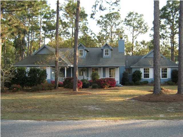 LOCATED ON 1.75 ACRES!!!! You MUST SEE this Well Loved Custom-Built Home! Only 4 miles to Navarre Beach and 8 Miles to Hurlburt Field! This Lovely Home is in a Park-Like Setting! The Living Room Welcomes you with soaring ceilings, wood floors and a beautiful Fireplace! There is a Formal Dining Room with a Trey ceiling! The Kitchen has lots of Beautiful Custom-Built Oak Cabinets, Granite Countertops, Newer Appliances, Large Pantry, Tiled Floors a Large Breakfast Bar and a Breakfast Nook with a high ceiling and a Palladium window! The Breakfast Nook and Dining Room both overlook the Gorgeous Back Yard! The Master Bedroom has French Doors that lead to the back yard. The Master Bath has an open Vanity with a separate Walk-in Closet and a separate Bath/water closet, Jacuzzi Tub and an
