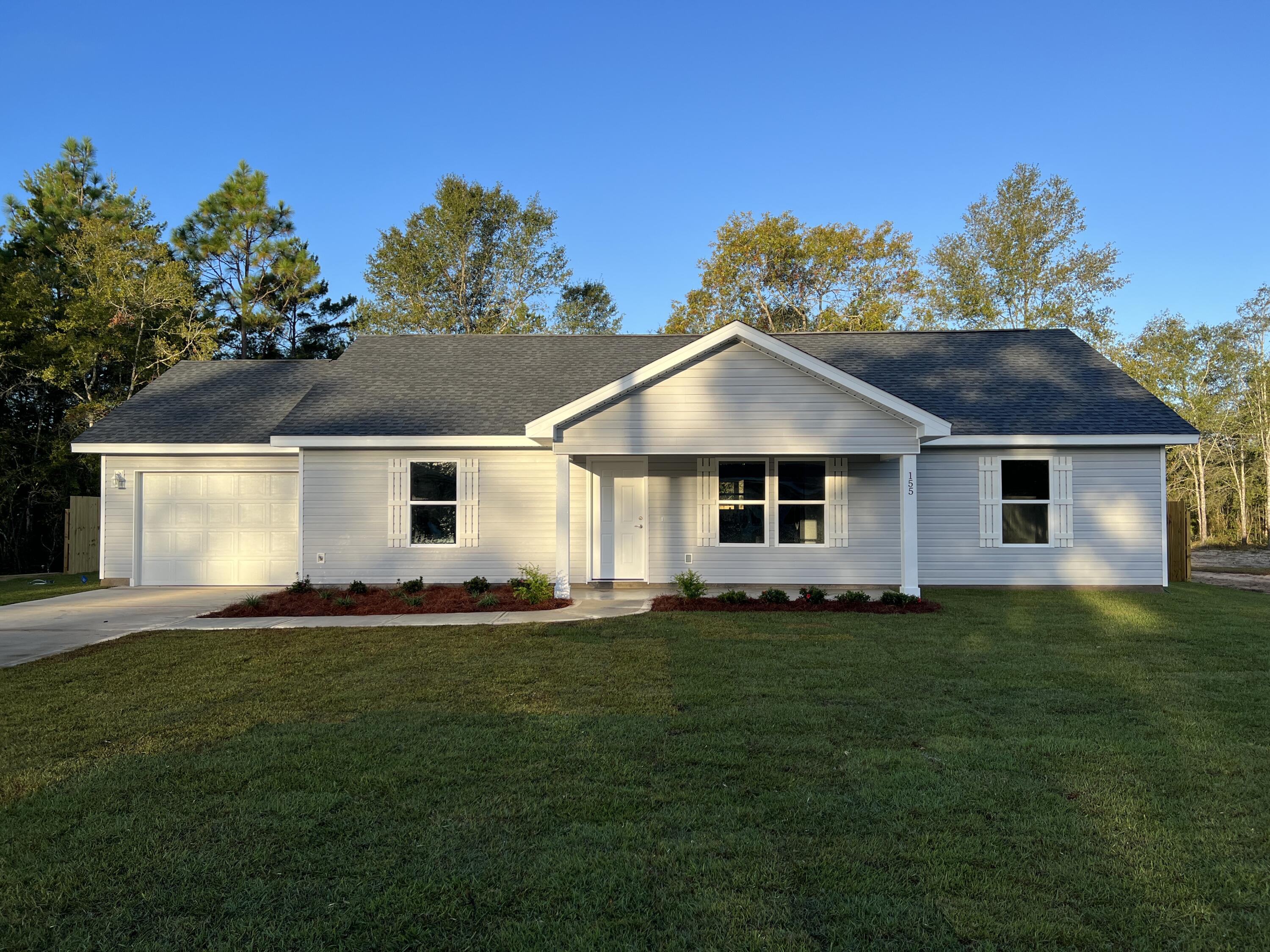 Discover this beautifully newly constructed home situated on a desirable corner lot, showcasing a modern design. As you enter from the front porch, you'll be greeted by a spacious open-concept layout featuring vaulted ceilings. This stylish 3-bedroom, 2-bath home features LVP flooring in all common areas, sleek white shaker cabinets, quartz countertops, and stainless-steel appliances. The covered back porch serves as a perfect retreat for relaxation or entertaining guests, while the private backyard, complete with a privacy fence, offers an ideal space for outdoor activities. Additionally, the garage provides for convenient parking. Located in DeFuniak Springs, this home is just 35 miles from the beautiful beaches of Walton County and less than 20 miles from Crestview. This is a must-see!