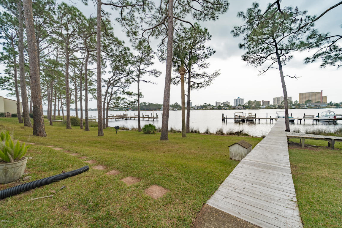 We love this ground floor, water front condo.This great looking ground floor unit faces Grand Lagoon and captures incredible views of the lagoon from kitchen, living room and of course the patio. This condo has been beautifully renovated including updated kitchen (with granite counter tops & new appliances) Wow! Not only are the views amazing, the atmosphere of this unit is park like and so peaceful. The dock has 10 boat slips. (they are rented for 600 a year although there is a waiting list it is certainly worth the wait!!) This complex has easy parking (no elevator needed). The location is awesome! Only a short boat ride to Shell Island. Only a short drive to Pier Park, Shopping and other entertainment. Come view today.
