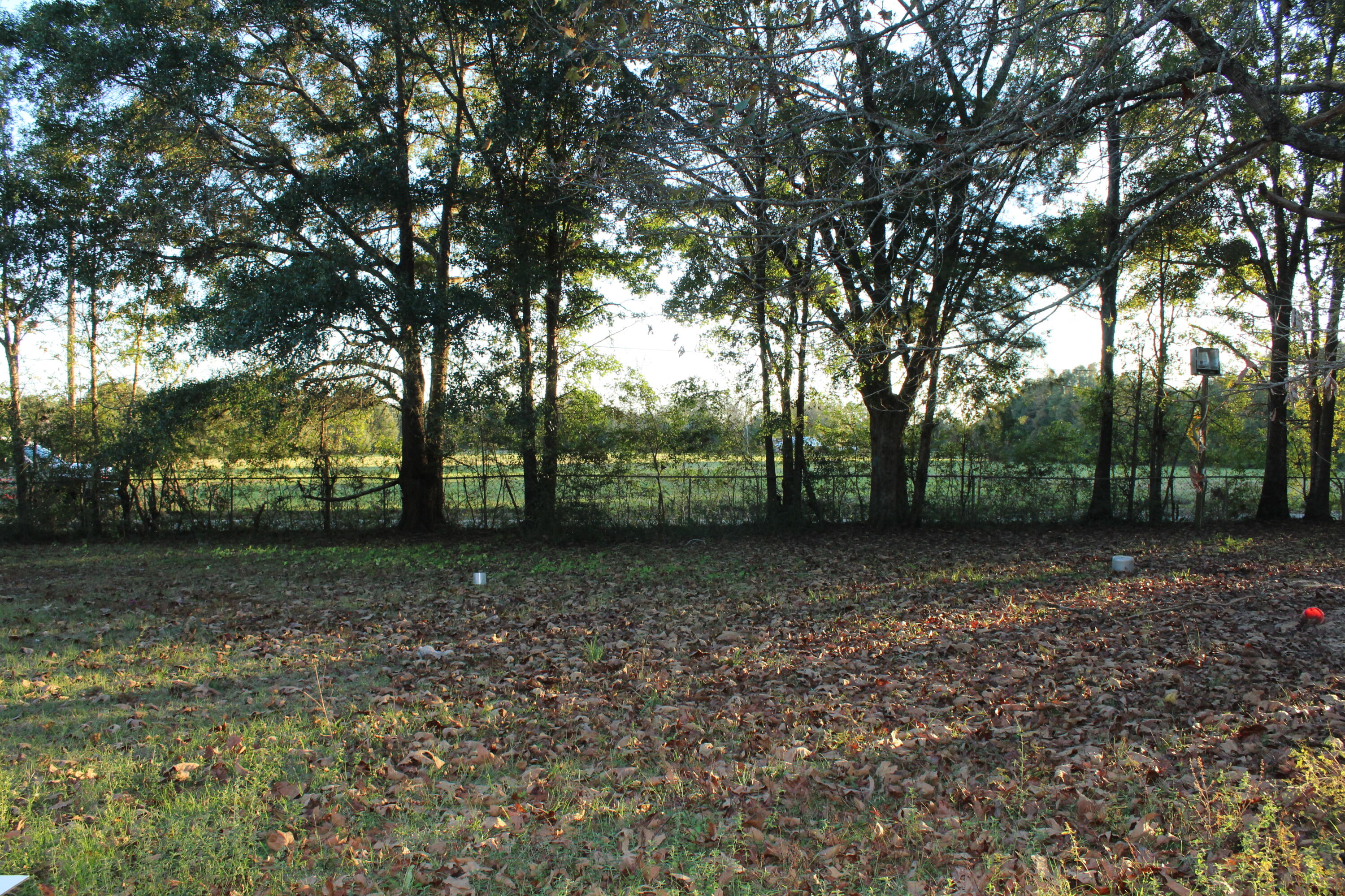 Beautiful lot 1.97 acres in prime location only 3 miles north of High School and close to Hwy 85 in Crestview, FL . Great investment for an owner occupant or investor! Live on one side and rent the other or rent both lots and/or set up airbnbs! Utilities are present on lot! Left half is cleared and has a mobile home (not to convey with sale). Right half has some fencing and not cleared. Tenant on the left side pays $400 for lot. Personal property on the left lot does not convey and is the tenant's property. Buyer to verify all dimensions and information