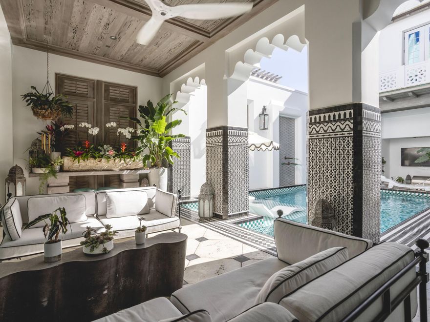 This exceptional residence offers the ultimate entertainer's dream, blending luxurious design with resort-style amenities to create an unparalleled living experience. Every detail has been carefully curated by Melanie Turner Interiors, inspired by global influences, ensuring a home that feels both immersive and unforgettable. At the heart of the home, a showstopping kitchen features custom wood cabinetry, a striking blue-and-white tile backsplash, and high-end appliances, setting the stage for culinary creativity. The expansive island, paired with plush, sculptural seating, seamlessly connects the living and dining areas, making it the perfect space for building memories. The outdoor living spaces are truly one-of-a-kind, with two pristine pools and hot tubs offering endless opportunities for relaxation and entertainment. The central courtyard pool, framed by intricate tilework and elegant archways, includes an integrated bar and grilling area creating a private oasis perfect for unwinding. 

Just steps away, a charming casita provides a secluded retreat for guests, complete with a full bath and bedroom. This private sanctuary allows visitors to enjoy their own luxury while staying close to the main home's vibrant spaces. Designed for effortless indoor-outdoor living, expansive nano doors open wide to reveal a beautifully integrated outdoor area. Guests can flow seamlessly between the indoor lounge and poolside, creating the ideal setting for sophisticated gatherings. 

The rooftop features a second heated pool, flanked by a fire pit sitting area, outdoor bar, and grilling station, an elevated escape with breathtaking views of Alys Beach. The owner's suite is a true masterpiece, featuring custom murals that bring artistry and luxury to the space. These hand-painted details transform the suite into a serene, tranquil retreat. The spa-like bathroom, with gold-accented fixtures and a sculptural soaking tub, enhances the sense of indulgence, while intimate corridors adorned with intricate lanterns elevate the home's elegance. Off the oversized balcony, a private office offers a quiet retreat with sweeping views of the courtyard, perfect for focused work or peaceful moments. Two additional bedrooms and full baths are located on the second floor, one of which features a Juliet balcony overlooking the courtyard. Effortless luxury continues with an elevator providing easy access to all three floors, offering ultimate convenience.

Thoughtfully designed with ample storage, this residence strikes the perfect balance between elegance and practicality, keeping everything organized without sacrificing style. Ideal for those who love to entertain and embrace an elevated lifestyle, this residence is a rare gem masterfully blending sophistication, comfort, and resort-style indulgence. Details such as Dens Armor Plus mildew-resistant drywall, hidden whole-home surround sound, and bespoke lighting elevate every moment spent within the home. Dedicated parking for two cars is provided in a rear parking court. 

Ideally located near Palmera Park, Caliza Pool, and Gulf Green beach access, a short stroll brings you to the owners' Beach Club, offering everything you need to enjoy the stunning white sandy beach.