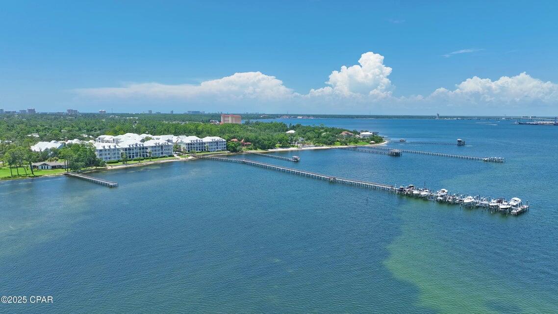 Welcome to coastal living at its finest! This stunning 2 bedroom, 2 bath condo is perfectly situated right off the water in a gated community in the heart of Upper Grand Lagoon. Featuring two private balconies with peaceful water views and a beautiful pool. This home is ideal for relaxing after a day on the beach or entertaining guests. Inside, you'll find a beautifully updated kitchen complete with sleek granite countertops and a high-end Viking gas stove perfect for cooking up your favorite meals. Both bedrooms are spacious, and the bathrooms are tastefully finished to provide comfort and style. Outside, enjoy access to a private dock with boat slips ideal for boaters and water lovers. You're just down the road from the beach, two grocery stores and a variety of popular restaurants. Whether you're looking for a weekend getaway, or a full-time residence, this condo offers the best of Panama City Beach living. Don't miss your chance to own a piece of paradise!