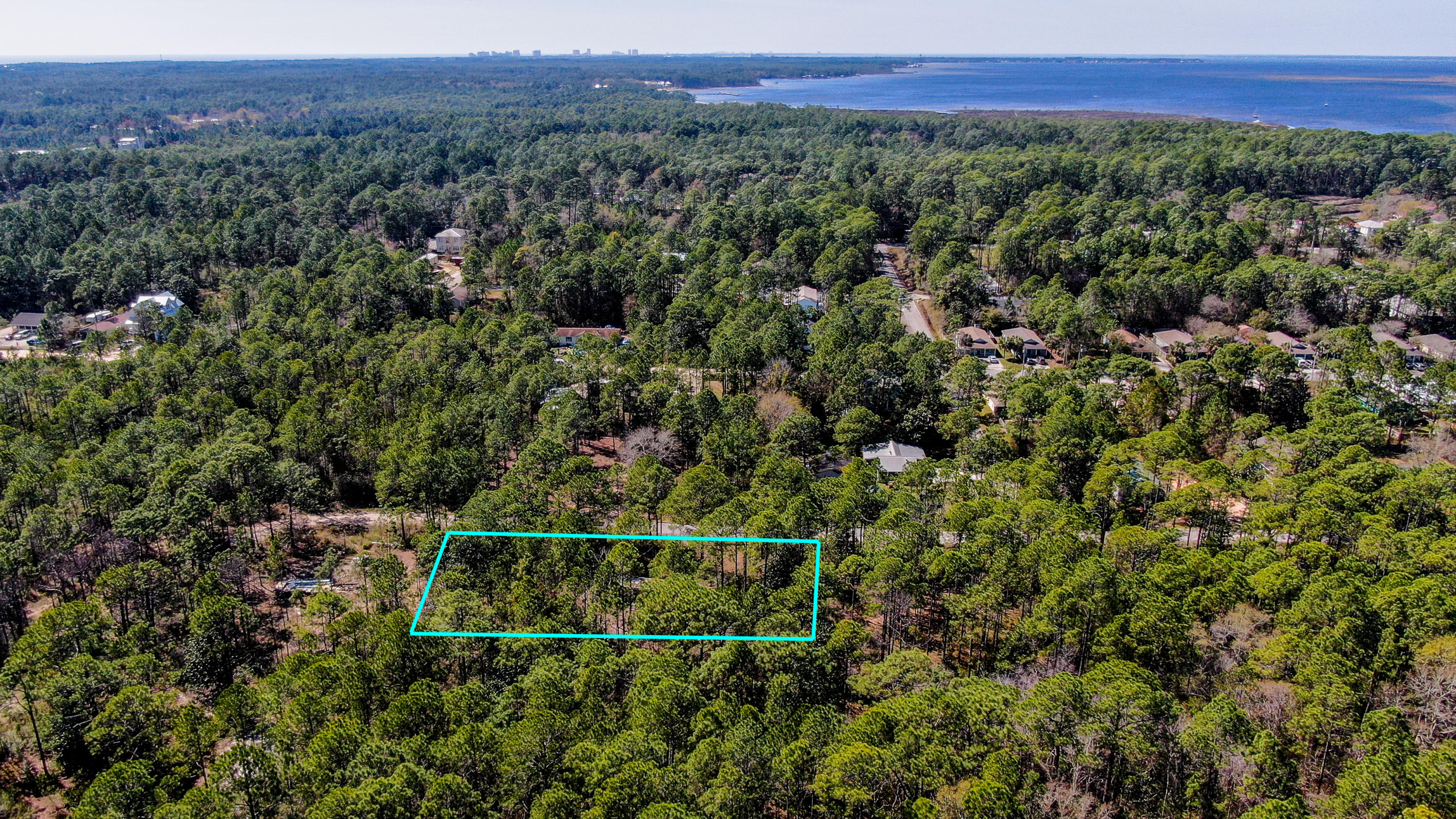 PRICED TO SELL. MUST CLOSE BY 12/31/20!!! This area of Santa Rosa Beach is growing again with building going on all around. This property is located within a mile of Hogtown Bayou and the public boat launch and is just a short car ride the Gulf of Mexico and the famous ''Beaches of South Walton''. This property is over a 1/2 Acres, (.57) and has 200-Feet along 6th. St. by 125-feet deep. It would make a nice homesite or you could possibly break it up into four 50 x 125 lots. The area is a mix of houses and mobile homes. Pretty pine trees and native scrub cover the property. There is an old trailer on property. Area schools and shopping are all close by and the entire area is close to all the outdoor activities that South Walton County is famous for.