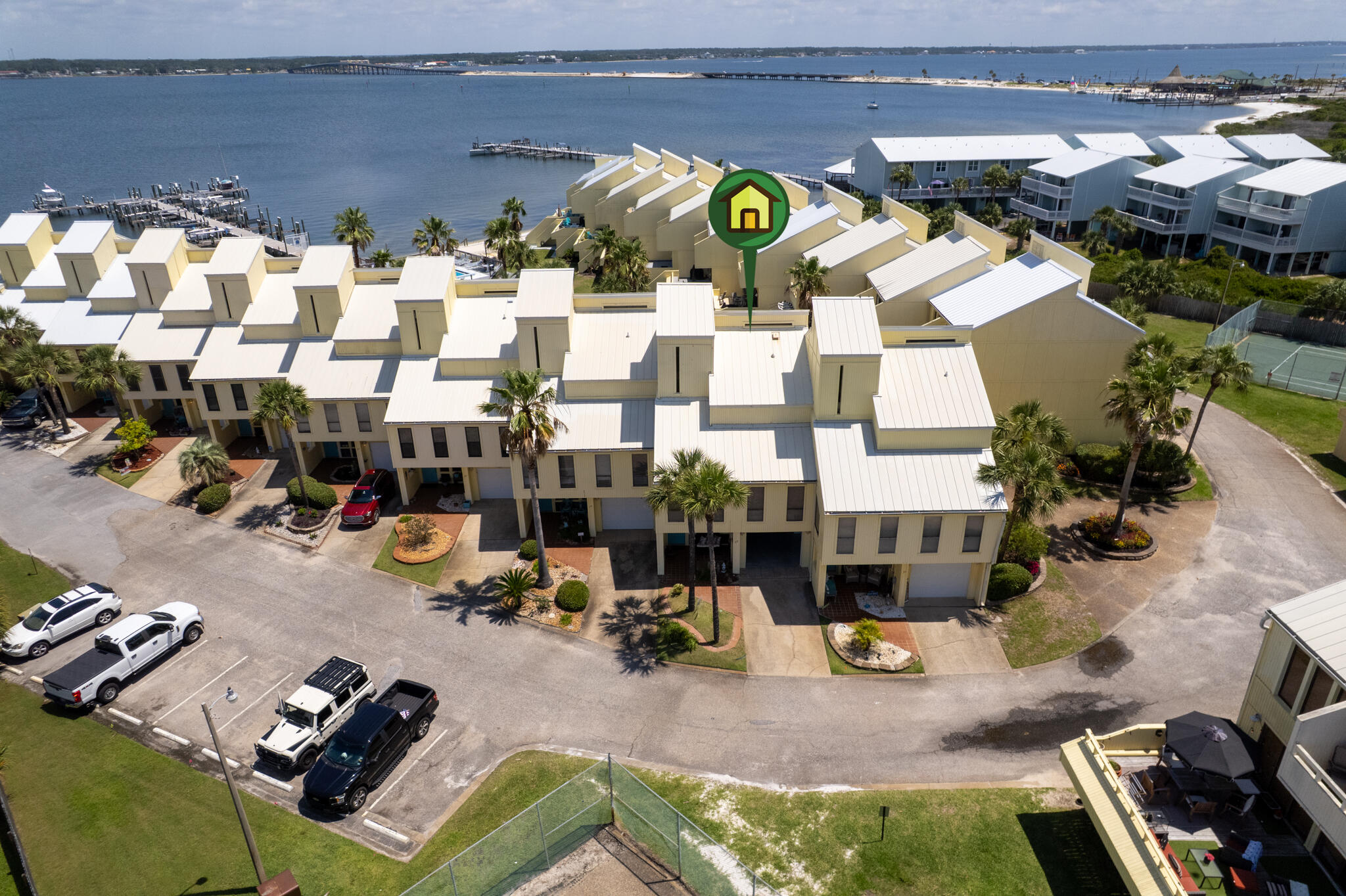 Beautifully renovated and fully furnished Navarre Beach townhome in the sought-after Buena Vida community! This property features Gulf and Sound views, an open-concept living/dining area, and a fully updated kitchen with granite counters and stainless appliances. Spacious bedrooms, including a top-floor primary suite with private balcony, oversized closet, and en suite bath. New luxury vinyl flooring, stacked washer/dryer, and mounted TVs in all bedrooms. Enjoy the large third-floor balcony and oversized deck overlooking the pool and lush grounds. Includes 1-car garage, bonus room, and 2 additional parking spaces. Assigned boat slip with power/water and newly installed 12,000lb top mount boat lift included. Community amenities: beach, pool, tennis, and dock.