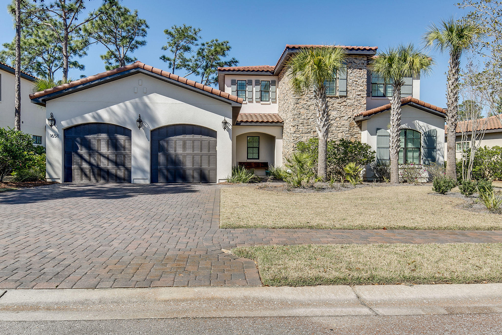 ON THE LAKE AT GENOA, this Huff Homes of Florida home was built in 2017. With 2 stories, 4 Bedroom and 4.5 baths, this home boasts a downstairs master suite overlooking the lake as well as 2nd Bedroom on the first floor. The second floor has 2 additional bedrooms, each with private bath, and a second living area perfect for a media room, office, or fitness room. This beautiful second home has lots of upgrades in addition to the usual Huff Homes great quality: 10 ft ceilings, 8 ft raised panel solid doors, crown molding throughout the main living area, and custom built-in closets. The gourmet kitchen has a stainless appliances (including gas stove), large island, bar area, cook's pantry, quartz countertops with under-mount sinks, and indirect under-cabinet LED lighting (just one example of