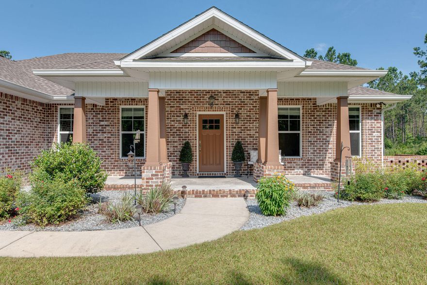 This nearly new 3 bedroom, 2 bath home is a rare opportunity to own almost 15 acres of land and still be just a few minutes from the major shopping and dining areas of Pace!  Located just off of Chumuckla Hwy, no details were spared when building this custom home!  From the gorgeous LVP flooring in the main living areas and bedrooms, the hidden pantry in the kitchen, black stainless steel appliances, pex system, his/her closets and the extra insulated exterior walls and ceiling, you can both see and feel the extra care in this home design.  Outside you will find a powered, insulated workshop, a 4-zone, 32-head sprinkler system, a whole house generator with it's own dedicated propane tank, and some pretty amazing trails that wind through the expanse of the property.