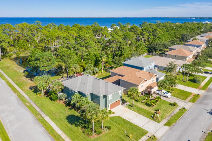 Recently renovated 4 bedroom / 3 bath home with HEATED ENCLOSED POOL!  This home, which sits on a corner lot with beautiful landscaping, is among the most desirable in the neighborhood of Driftwood Estates.  The recent renovations include: new vinyl plank flooring and new carpet with moisture barrier; new exterior and interior paint; new pool pump and sand filter; new HVAC system with 10 year warranty; renovated kitchen; and recently painted cabinets.  The large kitchen includes all stainless-steel appliances and opens up to the living space and dining area.  Each bedroom has large walk-in closets.  The master bedroom features a 205 sq.ft. bonus room overlooking the living area which is perfect for a home office or work-out area.  The outdoor living space is a must see! The centerpiece is a gas heated pool with sundecks and fountains surrounded by a stucco privacy wall topped with a screen enclosure.  The patio has brick paver flooring and is plumbed with gas to build a full outdoor kitchen.  It is the perfect spot for lounging and entertaining in privacy.  The enclosed pool deck leads to a backyard with new sod surrounded by a wooden privacy fence which is perfect for pets, gardening, or storage.  The home has a two-car garage with an extra nook for storage or work area, plus a storage closet.  The large corner lot has lush tropical landscaping, backs up to a pond, and is located just one block from the bay with walking path to the water.

Driftwood Estates is a family friendly neighborhood that features a community swimming pool, tennis courts, and a playground with walking trails. It is located just minutes to Sacred Heart Hospital and the restaurants and shops of Grand Boulevard.  It is just a 10-minute drive to the beaches of the Gulf of Mexico and 30A. Don't miss the opportunity to see this house!

Buyer to verify all dimensions.