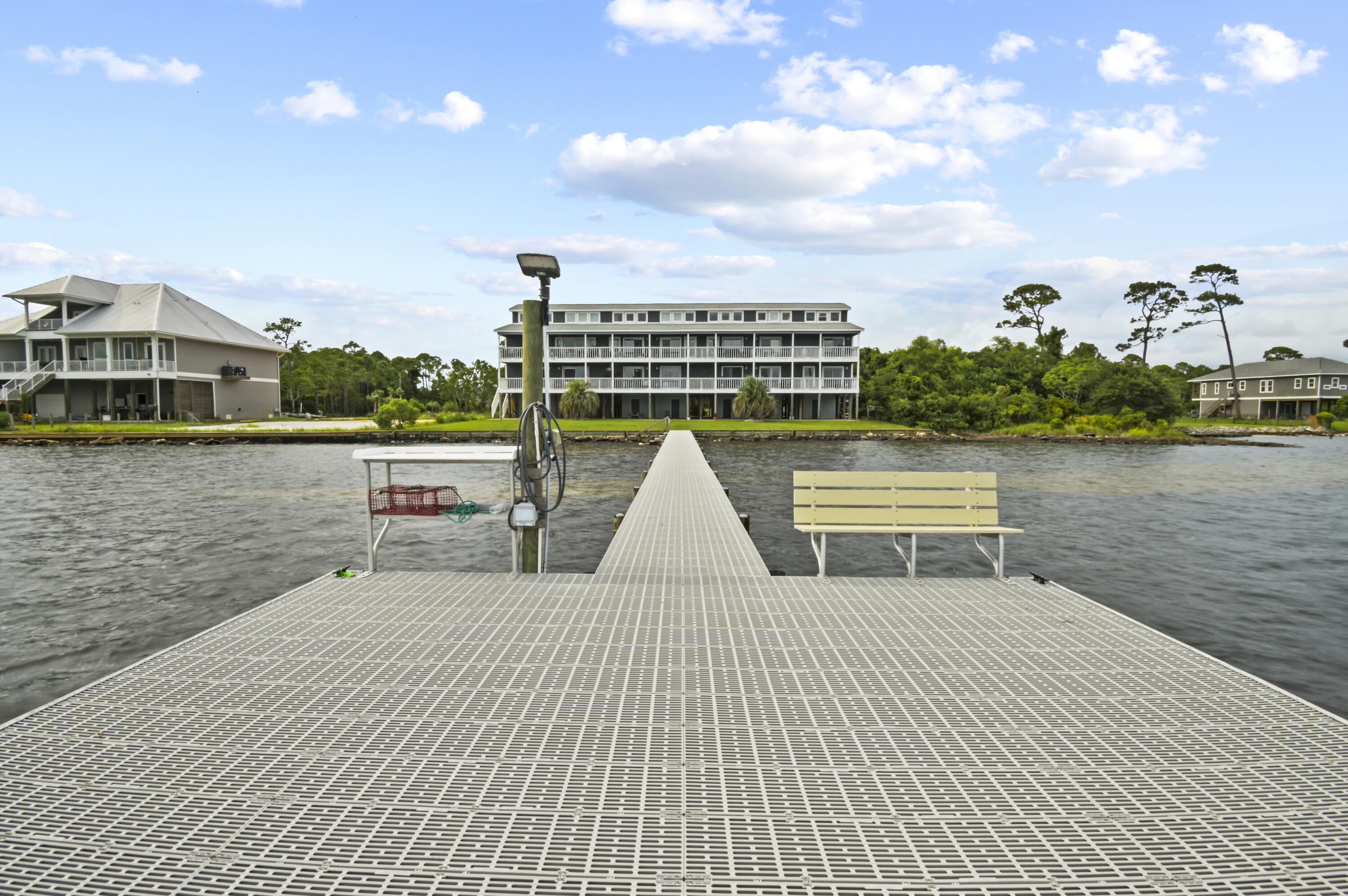 Welcome to this fully furnished, CORNER unit condo located directly on the Santa Rosa Sound. This beautiful condo offers a quiet coastal escape while still offering urban conveniences nearby in Gulf Breeze and Navarre. Stepping inside you are immediately greeted with unobstructed waterfront views from the corner-unit balcony. The split design provides privacy with the bedroom in the front of the condo, the updated bathroom in the center, and the living/dining area in the rear. The kitchen is spacious with abundant storage and all the appliances were recently replaced. The crown jewel of this condo is the MURPHY BED creating an additional bedroom for guests out of the living room. Stepping through the sliding glass door, relax with a coffee overlooking the scenic sunset views over the water. This unit includes two parking spaces and a spacious storage room. Community amenities include a newly replaced pier, a picnic area, a ladder to the water for swimming, canoe/kayak storage, boat docking, and a dry boat slip. Just down the road is a public boat launch as well! This condo provides a serene coastal escape unlike any other on the Emerald Coast, so stop by and make your waterfront dreams come true!