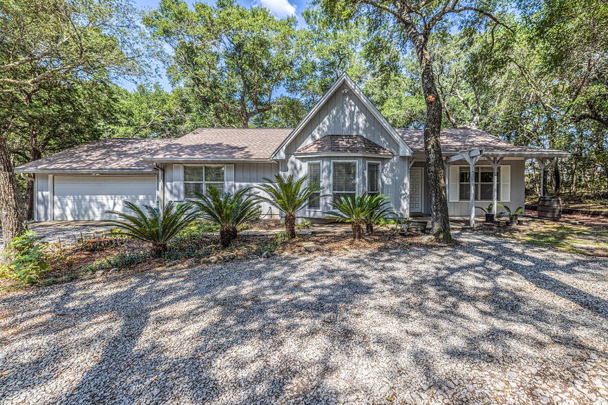 3 bed/ 2 bath home tucked away among the trees on nearly a .5 acre lot in Lake Sharon Estates! As you enter the home you'll delight in an open living space with soaring cathedral ceilings, bay window, and centered around a stately stone fireplace.Grand dining room adorned with skylights and leads into a sunny Florida Room for year-round enjoyment.Eat-in kitchen with sliding glass door access to the back patio which overlooks the huge backyard. The primary bedroom is a serene retreat, boasting an en-suite bathroom with walk-in shower. Desirable split-bedroom floor plan with 2 additional bedrooms both equally comfortable with hardwood flooring, and offering versatility for guest rooms, or home office.Large backyard with patio, and a 2-car attached garage for added convenience. 
Lake Sharon Estates is located between Choctaw Beach and the city of Freeport, making this an easy commute for those working on Eglin AFB. The Mid-Bay bridge is just a short drive away with access to all the wonderful offerings in Destin- Gorgeous sugar white sand beaches, restaurants, and shopping. 
Fireplace is non-functioning and will convey in "As Is" condition.
