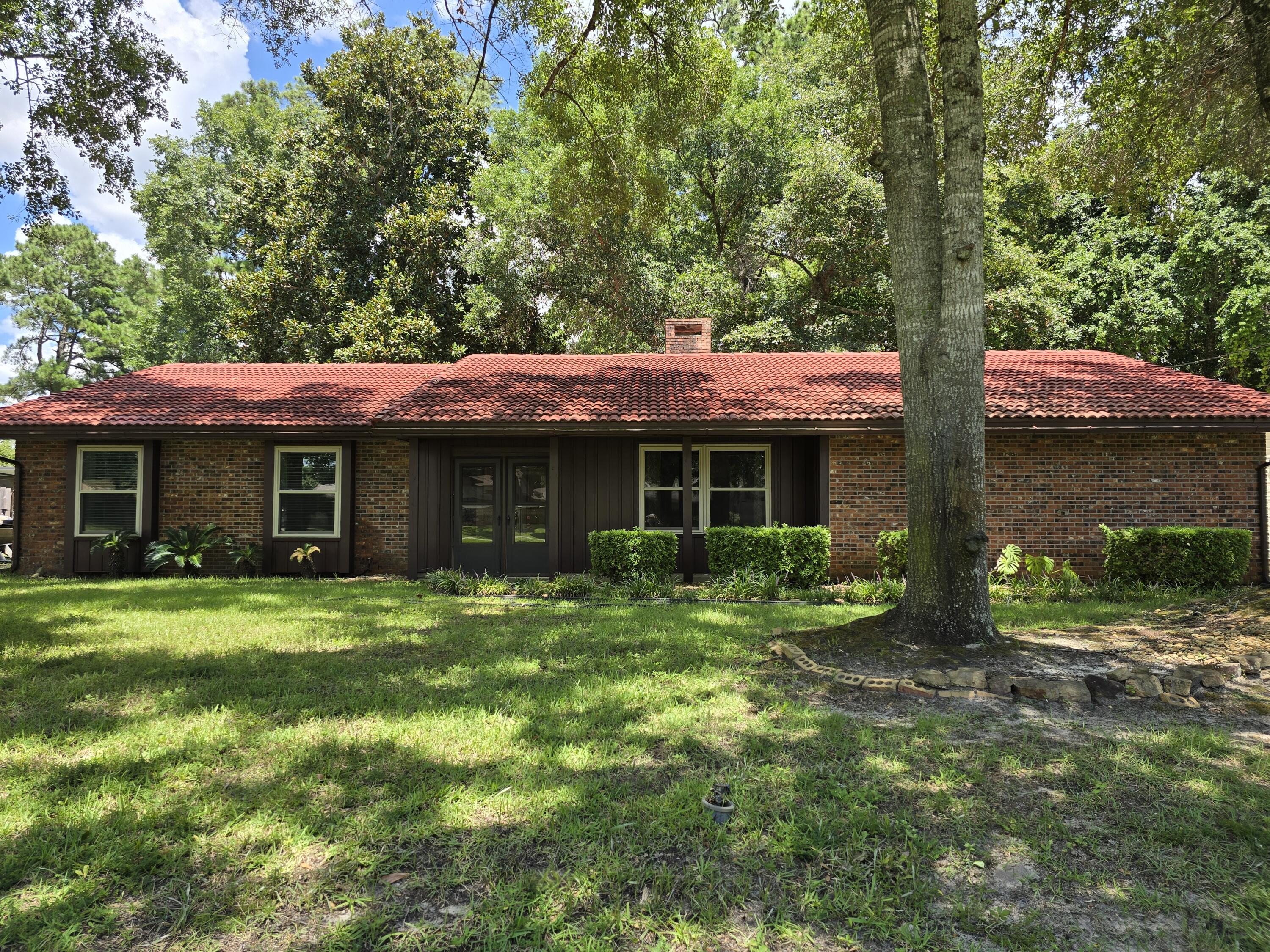 This well-maintained brick home sits on a spacious lot in the heart of Central Niceville and is move-in ready! Step inside from the screened front porch into a spacious living room, featuring a vaulted ceiling, a cozy fireplace, and an abundance of natural light. The open-concept kitchen offers abundant cabinetry, ample counter space, and a convenient breakfast bar. It seamlessly flows into a second living area and dining room--perfect for entertaining or everyday living. Sliding glass doors from the dining area lead to a screened-in back patio, ideal for enjoying the outdoors year-round. Adjacent to the family room is a flex space that can serve as an office or hobby room. It also offers washer and dryer hookups as an alternative to the oversized oversized two-car garage, where (click laundry is currently located. The primary suite overlooks the private backyard and features a spacious en-suite with walk-in shower and a generous walk-in closet. Two additional bedrooms and a full guest bathroom complete the interior.
Additional highlights include:
Side-entry garage for curb appeal and function
Greenbelt buffers to the right and back of the home for added privacy
24x20x9 workshop built in 2020, ideal for projects or storage
Recent Updates Include:
2020: Water heater and new workshop
2021: Garage door and expanded driveway
2023: Hurricane-rated windows throughout
2024: New HVAC system
Don't miss this opportunity to own a thoughtfully updated home in a desirable Niceville location. Schedule your private showing today!