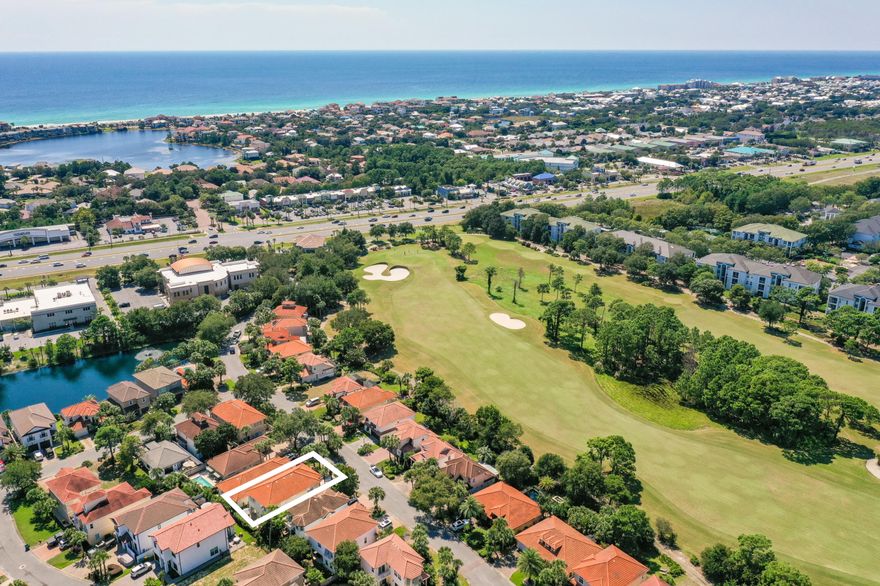 Set is lush mature gardens, this home exudes a laid back ambience with its tile roof, second-floor balcony and Bahamian-style shutters. Outside there's a driveway with inlaid pavers, mature landscaping, irrigation system and a two-car garage. Inside it wows with a plethora of extra features including cool tile flooring, crown molding, bright foyer and remote-controlled blinda. A money-saving Energy Selection Program manages the air conditioning, heating and hot water. Step into the open kitchen which boasts classy wood cabinetry, pantry, stainless appliances, feature tile backsplash and updated granite countertops for a high-end finish. The kitchen extends to a dining area and nook which lends itself to use as an office or coffee station. The open living room has ample space for a dining area and family-sized sitting area for putting your feet up. All the staged furnishing is available for purchase separately. There's a generous master suite on the first floor with his-and-hers walk-in closets. It has the added benefit of garden views and direct access to the terrace through sliding glass doors. Double doors lead to the master bathroom with twin vanity, soft under-counter lighting and a swanky jetted tub. The elegant staircase leads up to an attractive open gallery with ample bonus space for use as an office, sitting room, music, exercise or play area. There's an adjoining morning room for grabbing coffee and a danish, a generous laundry room and two further guest suites. One boasts a quiet sitting area and both have direct balcony access. The rear terrace is a peaceful private space for relaxing with a book or sharing a meal with family and friends. Mature greenery ensures a sense of privacy in an area lit by subtle exterior lighting on a timer. Just a block from the door, the community pool provides a social hub in this gated lakefront community just a half-mile from the sandy beach.