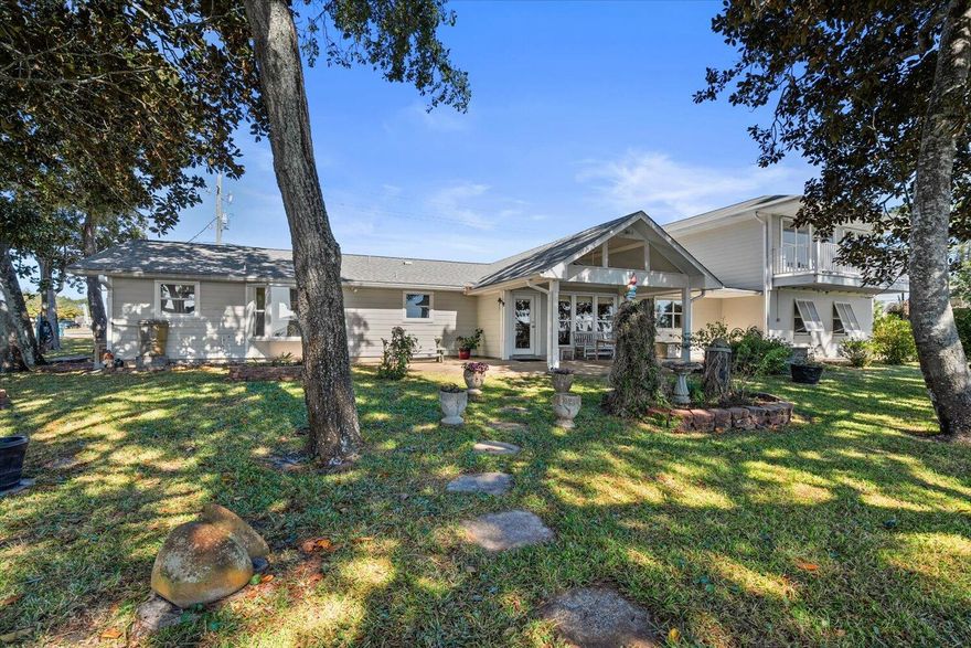 Must come and see this affordable remodeled waterfront home on close to a half acre, with dock, a main house with 3 bedrooms / 2 baths, and a separate 1,200 sq ft in-law quarters including bedroom with 2 walk-in-closets, full kitchen, bath, and laundry! The 115 ft on the Santa Rosa Sound has its own beach with a bulkhead and dock, which makes it an awesome place to relax on your beach or lounge chair! The home was completely remodeled in '05-'06 to include insulation, electrical, windows, interior walls, doors, porcelain tile flooring, new hot wtr heater in the main house, to effectively be new! In '08, a fabulous porch was added to the back to accentuate the cathedral ceilings inside the home! In '21 the home was upgraded w/ a new 30 yr roof, as well as ... (Pls see More) the HVAC in the main house and new compressor for the HVAC at the guest quarters! Also, in '21 the main part of the home had the plumbing updated, and a new fridge, dishwasher & disposal were installed! The guest house was built above the concrete block garage in '08, which features stunning views of the Santa Rosa Sound from the living room and kitchen, as well as the 20 ft deck overlooking the sparkling waters! A safe room was added when the apartment was added. This home is a must see, as the living and dining room boasts a 14 ft cathedral ceiling! The home's updated flooring is porcelain tile throughout the living room, dining room, kitchen, breakfast nook, laundry, all bedrooms, bathrms and hallways! Set up your own business as the huge 400 sq ft office can easily be used for professional purposes, with its own entry from the circular driveway on Hwy 98! Need another bedroom? Put a wall closet or use the 5 ft x 20 ft room off the office as a closet to make a huge bedroom for multiple children! Even more, the well was replaced for the sprinkler system in '08, the hot wtr heater to the guest apartment was replaced, and there are separate security systems for the main house and in-law quarters! There are even more features added, including a ramp to the home near the office, so call for your appointment, today! You will love the calming effects of these fabulous water views! Don't hesitate to make your appointment, today, to see this special home that could also be your office with a rental attached! Cheers!