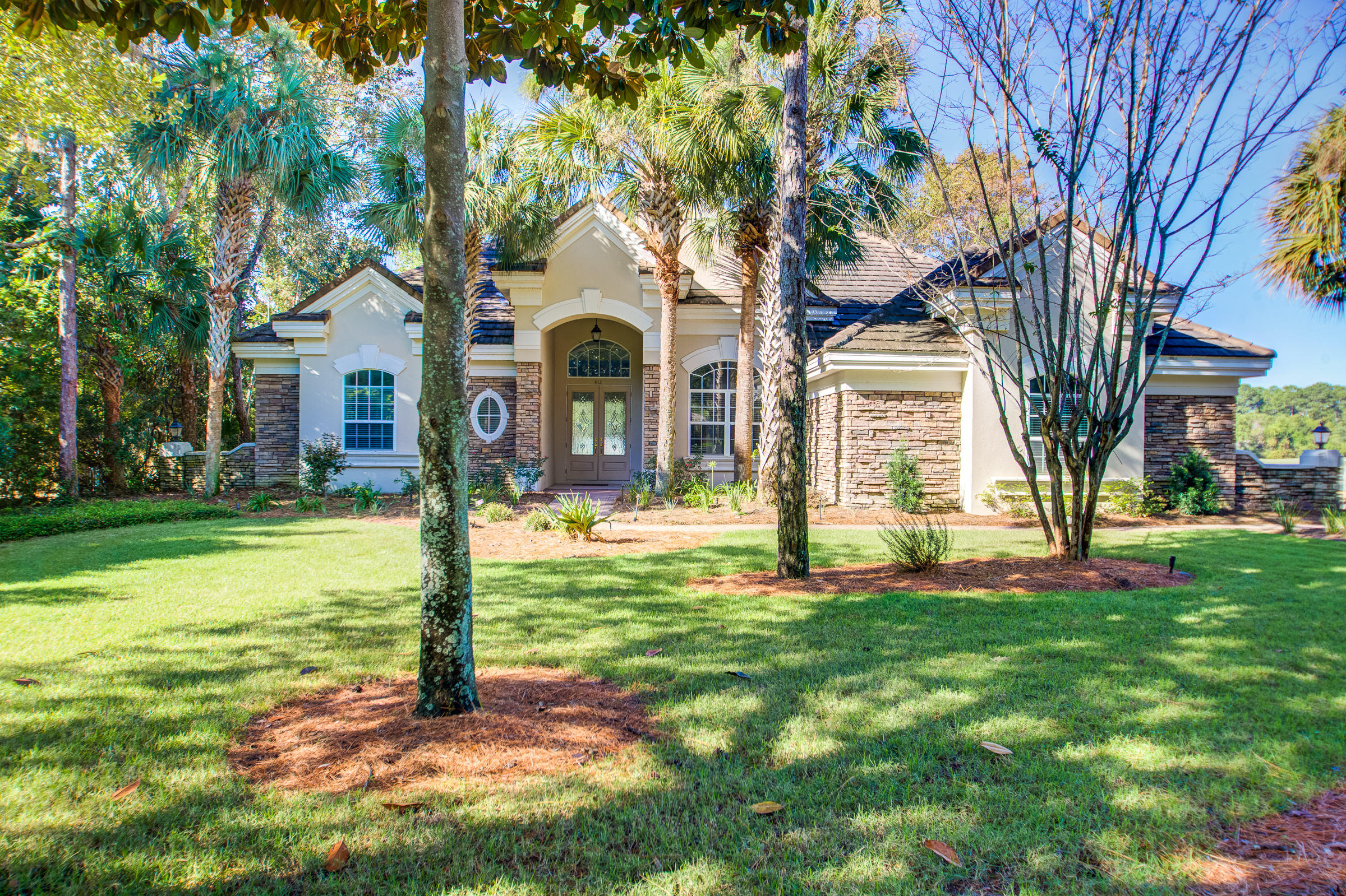 NOW OFFERED AS-IS AT AN UNBELIEVABLE price for a recently remodeled home in the upscale residential community of Regatta Bay Golf and Yacht Club. Originally a model home built by Arthur Rutenberg, now has been given a new life as remodeled to latest trends. Bright and airy with a large open floor plan announces new flooring throughout - exceptionally durable vinyl hardwood graces the main living areas, with new carpeting in all bedrooms for comfort. Kitchen impresses with new white self-closing cabinetry, GE stainless steel appliances include microwave, dishwasher, double ovens, spacious island with a quartz counter top, and new stainless steel sink - all shine and are complemented with glass tile back splashes. Master Bath presents with double vanities, quartz counter tops, tiled shower relaxing bat tub and new tile flooring. Captivating curb appeal is enhanced with an elongated drive, and nicely landscaped with a new front lawn. The pool has been resurfaced. All await a new buyer. This home boasts a rare three-car-side-loading garage - all situated perfectly to enjoy lake and hole #2 golf course views. This spacious home will be a favorite for families, as 4 bedroom homes are in demand. This split bedroom plan allows for privacy, while the large Kitchen and Leisure Room offer a natural gathering space. The bonus room is exactly that - may be used as a home office or one may opt to use it as an exercise room, or perhaps a children's recreational room. The main living areas are bright and airy and offer amazing elongated views from the front entry to the lanai, pool and beyond. Trendy tone on tone colors afford simplicity in making this home YOURS! Fido even has a fenced outdoors area. Property is located in an X Flood Zone. Owners and their guests have access to all the neighborhood amenities which include tennis courts, pools, children's playground, sport lake fishing, and the nature trails that meander throughout. Destin Commons Mall, Whole Foods, and Lulu's Restaurant are all located just outside the gates! Legendary Marina is conveniently located for boating enthusiasts. And, just a few short blocks south is the Gulf of Mexico! Regatta Bay has easy ingress and egress - truly a coveted community! Buyer to verify all important data.