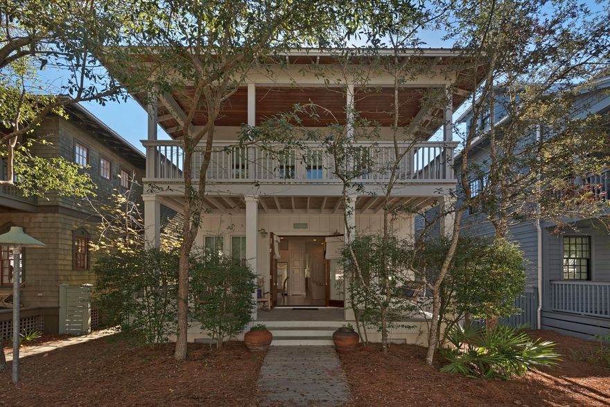 Charming Home with Inviting Porches in Rosemary Beach
Located less than five blocks from the beach, on a quiet, tree-lined street and adjoining a beautiful community pool and playground enhances the appeal of this enchanting home. Two large front porches feature wood ceilings and floors. Low maintenance landscaping, an outdoor shower and brick courtyard in the enclosed backyard are perfect amenities for either a quiet or busy lifestyle. The crisp white interior evokes a contemporary atmosphere throughout. Hardwood floors, shiplap ceilings and recessed lighting contribute to a modern coziness. A recessed sofa creates a wonderful reading nook and built-in shelves in unexpected places add to the easy living atmosphere.
The open kitchen features stainless steel appliances and a breakfas or wine bar counter. The master bedroom is elegant for its cathedral, beamed ceiling and double French doors to the second story deck. The bath sports a corner, jetted tub and an oversized rectangular sink. A nice bun k room o pens to the upstairs deck, and the third bedroom is comfy. There is double the charm here because while the home has a unique appeal all its own, Rosemary Beach completes the lifestyle with its own brand of magic. Strong rental track record.
