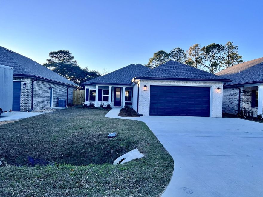 Come see this beautiful 4 bedroom,  2 bath all brick home sitting on a corner lot and is located at the East end of Niceville. The seller pays 10,000 towards the buyer's closing cost, doc stamps on deed, & all title insurance and title fees.  You'll absolutely LOVE this OPEN floor plan featuring 9ft. ceilings throughout and 10ft where reverse trey ceilings are located. This home boast many custom amenities. 8ft front and garage door, extra parking pad for a boat.  The kitchen is divine, featuring white custom cabinets, soft close drawers, farm sink, pantry, undermount lighting under cabinets and quartz countertops throughout. The island bar has an 18 inch over hang, a reverse trey ceiling in the family room with changeable lighting for seasonal events.  Enjoy the floor plug added to he family room for phone chargers, lamps without cords and hindering walkways. Love entertaining? The kitchen and family room open up to a screened porch to relax with an extra paver pad for grilling and an extra patio set. The master bedroom has a reverse trey ceiling with recess lighting and opens up to a custom master bath. You'll absolutely love everything about this bathroom! It's wonderful for relaxing, with endless hot water with it's tankless hot water heater and the deep 6ft soaker tub. The master shower, boast custom tile with a rainhead, and 2 other separate sprayers, bench for sitting while shaving and seamless glass. You will actually want to do the laundry, with a custom folding table with quartz countertop, hanging bar and custom designer hooks attached. When you want to relax, and rewind, the back yard is the place. You'll enjoy a fully sodded yard, full gutters, sprinkler system that works off a separate well and a 6 ft. privacy fence, making up-keep easy. This home has everything and sits on a corner lot. Theres an alley road for these homes that give an entrance to the back yard as well. A double gate has been installed on the back right fence. For energy efficiency, the builder has installed upgraded spray foam in the roof. You will also enjoy the storage above the garage. The whole family will love the location! This builder takes great pride in his homes and it shows! Five new homes are under construction. Your close to restaurants, a large park with boat launch and Eglin Air Force Base, Special Forces, Emerald Coast beaches, shopping, hospitals and more. Call today for a viewing, and Welcome Home!