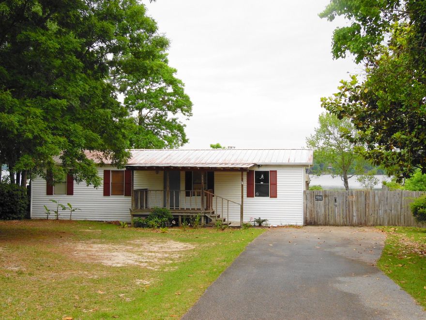 Waterfront delight! Beautiful sunsets... This 1984 double-wide mobile home is located on one of the most beautiful sides of Lake Juniper. This lake is known for record size bass up to 17 lbs...bream, blue gill, catfish and more. Home has 3 bedrooms, 2 baths, fireplace, built on back porch and covered area for cooking out, dock, city water and septic. Seller is selling it partially furnished. Easy to show.