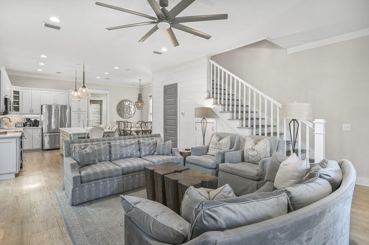 Custom-built by Core Construction in 2017, this exclusive beach house has never been on the market. Arranged over three floors, it boasts shady porches on all 3 levels and a high-end finishes including luxury vinyl plank wood flooring and ceramic tile in the bathrooms. The spacious open great room has ten-ft. ceilings creating an airy living space for relaxing or gathering with family and friends at the end of the day. Soft tones inspired by the sea are complemented by textured furnishings and subtle lighting, inducing a sense of calm relaxation. Play board games around the dining table after feasting on tasty local seafood. The well-planned kitchen has an enviable range of high-end Kitchen-Aid appliances along with white Silestone counters and a lengthy breakfast bar. The innovative desig