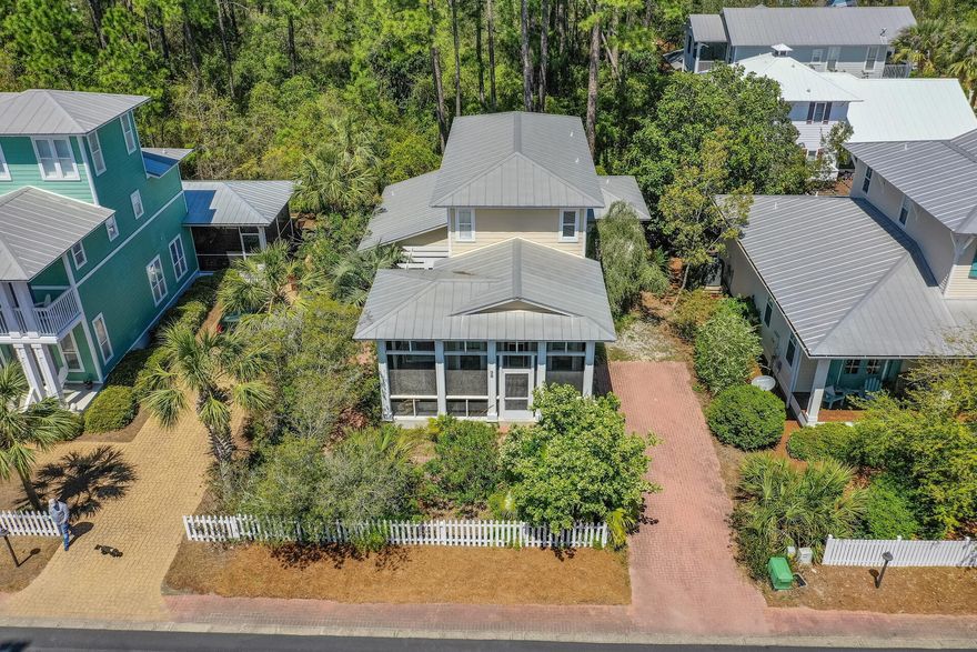 This charming Florida style cottage is located in Cassine Village in popular Seagrove Beach. Upon arriving you are welcomed by an inviting front porch overlooking a manicured landscape. Upon entering the home you will find an open floor plan, a living area, dining area, hardwood flooring, breakfast bar and an additional screened porch off the dining room. The Master suite is located on the first floor.  Two bedrooms, a full bath, custom bunk room and a separate living area are all located on the second floor. This beautifully designed home allows for plenty of natural lighting, with an indoor/outdoor living concept and is located within walking distance to 2 beach walkovers, 2 pools, tennis, hiking and fitness trails surrounded by twisting oaks and massive cypress! This home is a must see!