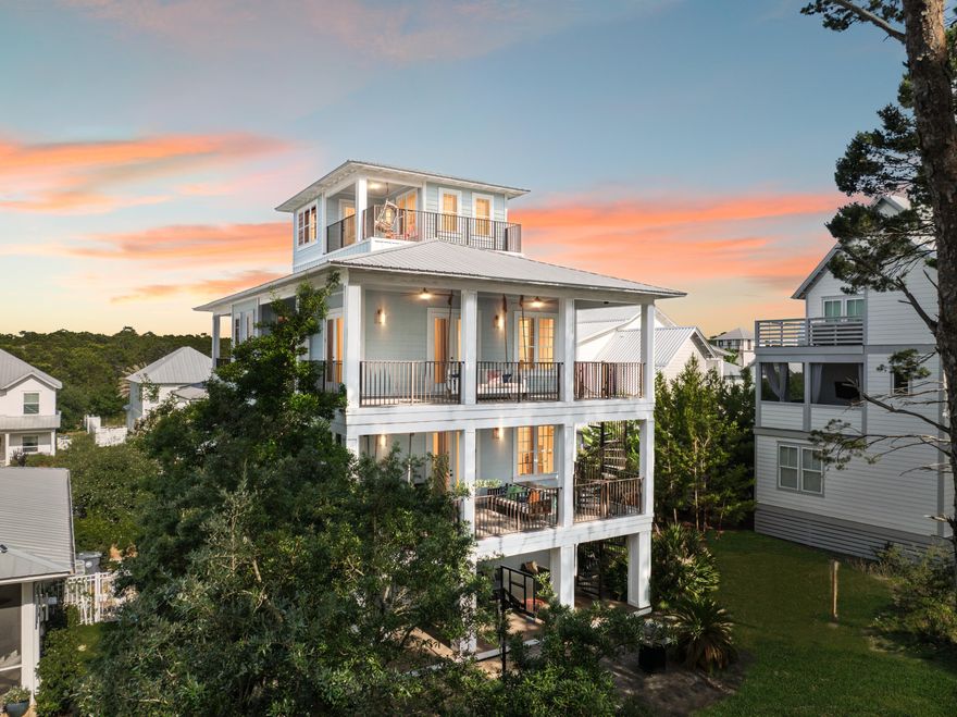 Nestled on a quiet street in the sought-after Grande Pointe community, this four-story beach home in Inlet Beach is the ultimate vacation destination for large groups. Boasting five bedrooms, five bathrooms, a bonus bunk area, and over 3,000 square feet of living space, this coastal residence offers an ideal blend of luxury, comfort, and functionality.From the moment you arrive, you'll appreciate the thoughtful design, including an elevator for effortless access to all levels. The ground floor features a charming bunk room with a full bath, direct access to a covered patio, and a spacious, fenced backyard--perfect for relaxed barbecues or a friendly game of basketball on the paved court. The second floor showcases an open-concept living space adorned with soaring ceilings, hardwood floors, and designer lighting. A spacious living room, dedicated dining area, and gourmet kitchen create a welcoming environment for entertaining. The kitchen is fully equipped with an electric cooktop, double oven, custom range hood, wine refrigerator, and a granite-topped island that serves as a natural gathering spot for meals and conversation. A full bathroom and well-appointed laundry room complete this level.
Retreat to the third floor where the luxurious primary suite awaits, complete with a private covered balcony, an oversized walk-in closet, and a spa-inspired bathroom featuring a deep whirlpool garden tub, separate shower, and double vanity with makeup area. An exterior spiral staircase connects the balconies across three floors, leading down to the private backyard oasis.
The top floor features an additional bedroom with access to the crowning balconyan ideal perch for savoring morning coffee or evening cocktails with sweeping views of the treetops and refreshing sea breezes. In total, the home offers four balconies, each with its own unique vantage point to enjoy the coastal surroundings.
This fully furnished home includes a new dishwasher and washing machine (2024), a new hot water heater (2021), and a fully upgraded elevator electrical system (2022). A two-car garage with additional parking for four vehicles ensures ample space for guests. The entire home was recently painted inside and out, offering a fresh, move-in-ready feel. Located just a short walk or golf cart ride to Lake Powell and Camp Helen State Park, the property also enjoys access to community amenities including a pool, clubhouse, and dock. Perfectly situated near the shops, restaurants, and golf courses along 30A, this property is ideal as a full-time residence, vacation retreat, or short-term rental opportunity.