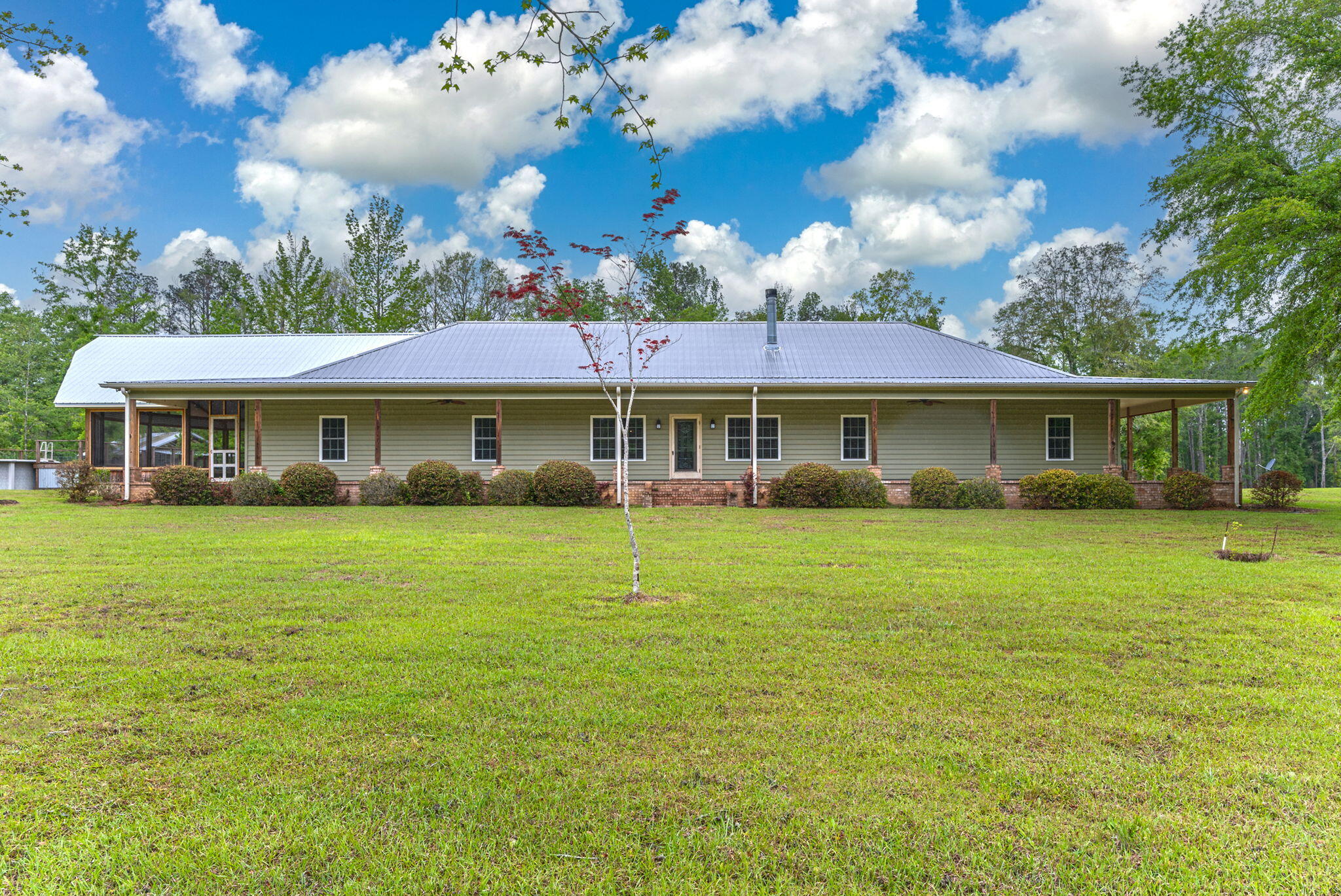 Located 10 miles over the Florida line here is the dream property you have been dreaming about.  This custom built 3330 sqft home has EVERYTHING on your check list for must haves. This home welcomes you with covered porches on 3 sides into an open floor plan. Home has a large living, dining and kitchen with all the upgrades which allows for perfect entertaining. The master suite is amazing with so much room along with a home office that could be used as a nursery or separate den for your own privacy, a master bath with every detail and huge walk-in closet, along with your own private exit to the covered and screened porch. The home has 2 additional bedrooms with a Jack and Jill bath that connects with separate walk-in closets. This right wing of the house also offers a family room.