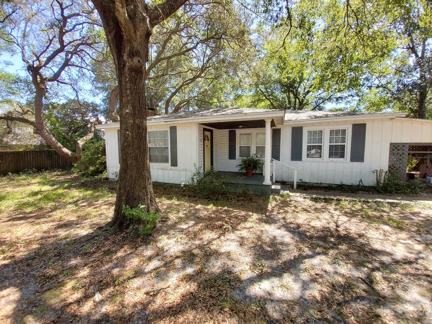 Florida Cottage style single level home located near shopping, restaurants, Eglin Air Force Base, Hurlburt Air Force Base and the Beautiful beaches of the Emerald Coast.  Enter a covered porch to find a living/dining room with fireplace and laminate flooring throughout.  Kitchen has vinyl flooring and white painted cabinets.  Kitchen leads to a family room that could be a dining area or office. Enjoy evening breezes on the screened porch.   Three Carports with this home. One is attached to home and the other two are detached.  The  Double Carport is attached to a workshop with electricity.  Perfect space for projects.    Opportunity to own a home for under $175,000 conveniently located in Fort Walton Beach.  Home offered ''As-Is''
