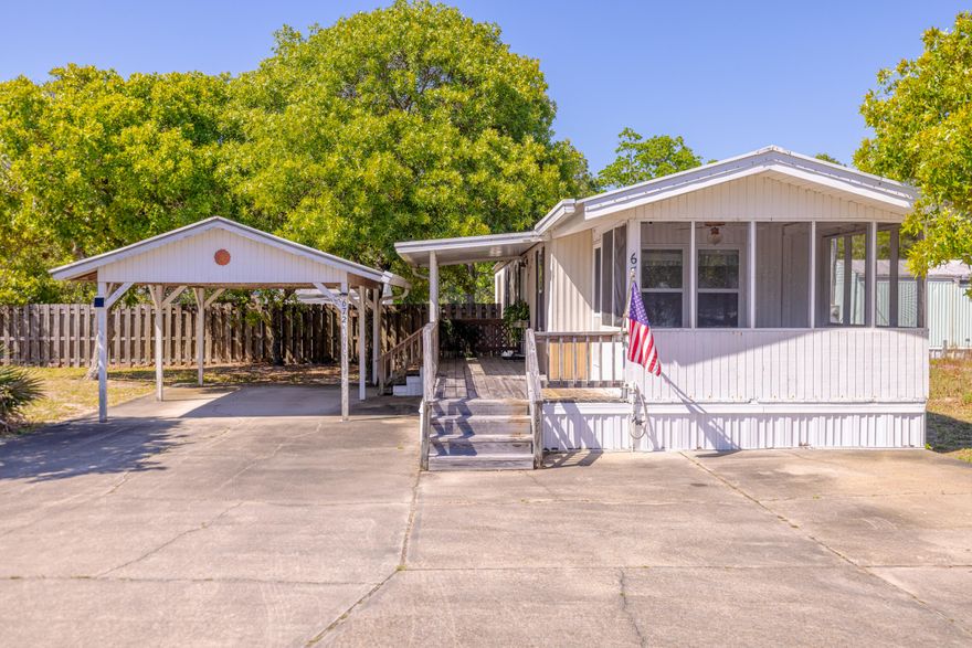 Experience coastal comfort with this adorable, fully furnished mobile home on the desirable west end of PCB. Ideal for beach lovers, investors, or those seeking a vacation home, this property is a must-see. Situated just blocks from the sugar-white sands and emerald waters of the Gulf, this home offers the ultimate beachy lifestyle with NO HOA fees. Step inside to an open-concept floor plan with a spacious kitchen featuring a darling breakfast bar, perfect for morning coffee or casual meals. Relax in the Florida room, ideal for year-round enjoyment, or entertain on the covered deck, surrounded by a large, fully fenced backyard with a handy storage shed. Parking is no problem here! The oversized driveway and carport accommodate up to 6 vehicles (SEE ADD REMARKS) ...making it perfect for gatherings or rental guests! Location is INCREDIBLE with easy access to the beach or explore nearby hotspots like Thomas Donut & Snack Shop, a local favorite for ice cream and fresh donuts. Grab groceries or a bottle of wine at Carousel Supermarket, complete with a wine cellar and gift shop. There is plenty of dining options in the area and entertainment options are endless! To the east, Pier Park has plenty to offer, including new attractions like TopGolf and Dolly Parton's Pirates Voyage dinner show. Carillon Beach and scenic 30A corridor are a short drive west. Schedule a showing today to see this gem! Perfect for vacation homes, investment properties, or year-round living.