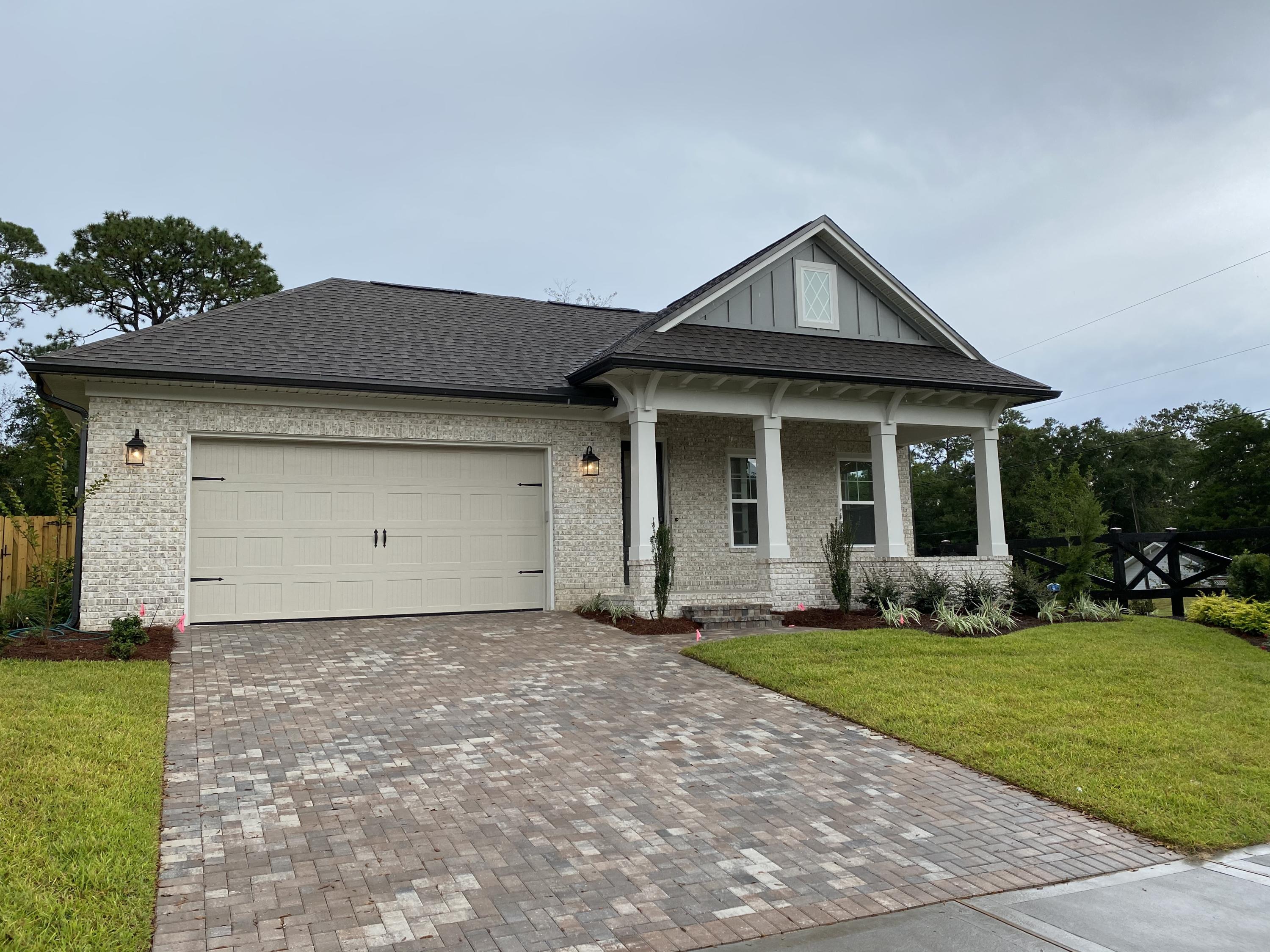 Beautiful Cobia floor plan with views across to Boggy Bayou. One of a kind and will not last long. This home design offers and open living concept . Open and bright kitchen features upgraded quartz countertops and furniture grade Woodharbor cabinets. Kitchen also has full built in stainless appliance package. Beautiful custom tile in all 3 bathrooms with Master bathroom featuring a free-standing tub and shower with 2 heads and frameless glass surround. This home also includes a laundry room that is accessible from the master suite and secondary bedrooms. Additionally, this home includes a Ranai tankless gas hot water heater, fully sodded and sprinklered yard, pavestone driveway, fenced rear yard, smart home security, 8' doors and 9' ceilings. Ready now for move in!
