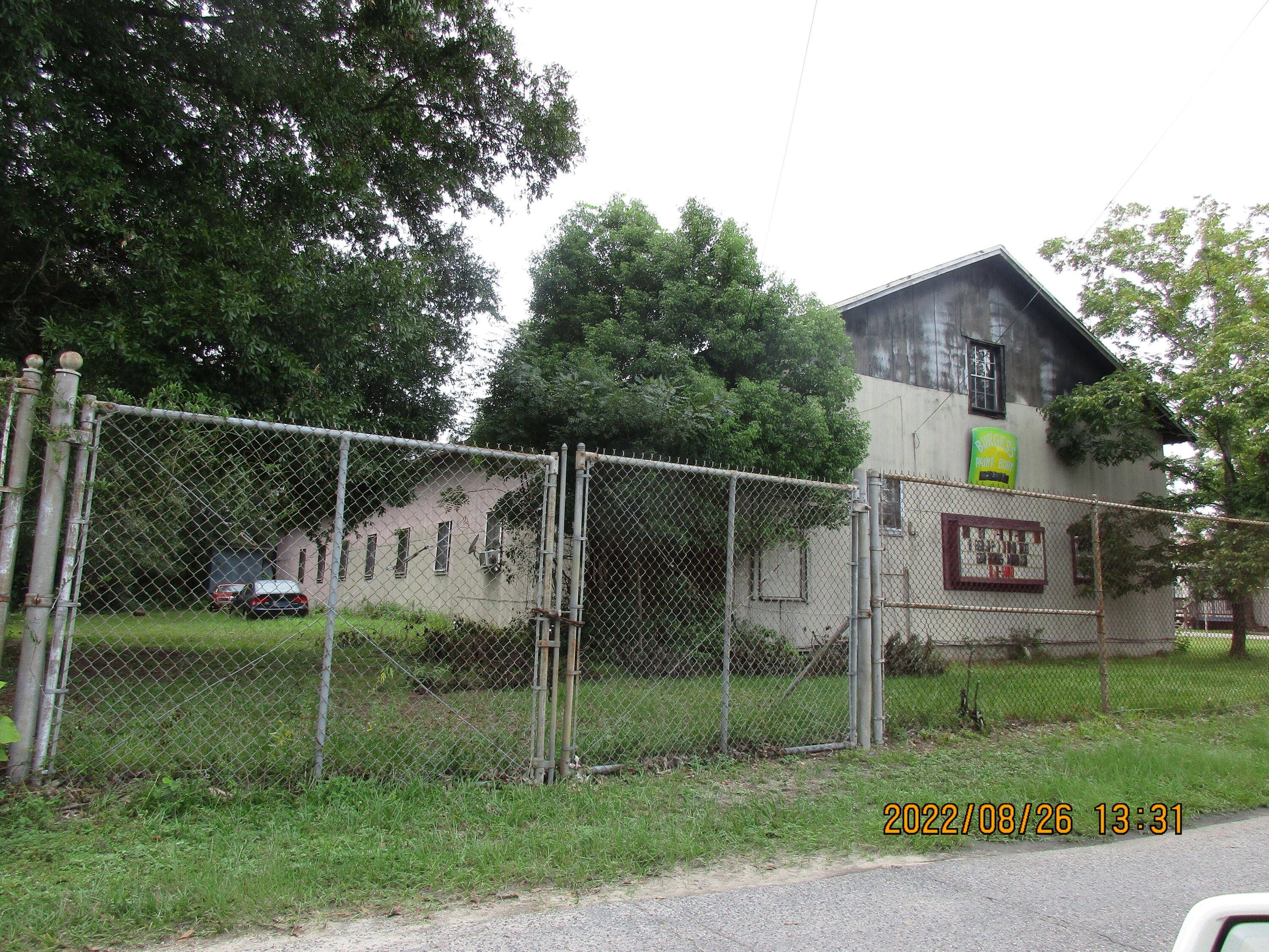 Owner Financing... This is a huge building that has been used as a paint and body shop for about 25 years. The owner now says it time to retire. It has a 2 bedroom apartment that needs to be finished but owner is using it currently. there is an office in the building. This a separate factory paint booth in a different building.There is a separate building with a paint mixing booth. There is chassis Linerfor straightening bent frames that also goes with the sale. There is plent ofroom to rent out space to other people who do car work. It is a well establishedbusiness and has a good view from highway 90. Building needs some workon one side of the roof but has a newer roof on the other side of this very large building. It has large large storage upstairs. high chain fence.