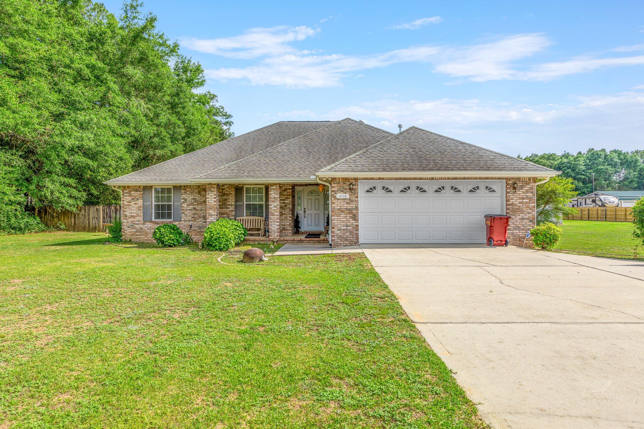 Welcome home to 1006 Stanley Lane! Beautiful home sitting on 3+ acres with an enclosed pole barn, two sheds, and additional RV carport. Everything you desire is in this home! Three bedrooms and two bathrooms, formal dining, and breakfast area. All brick with a nice size back patio, perfect to enjoy your morning coffee and hear the birds chirp. Enter the foyer to find an open concept living room and kitchen with tray ceilings. Youll also enjoy the split floor place with nice Master en suite. You will love the beauty, peace, and serenity this property holds, while being 15 minutes from Crestview. This home is a MUST SEE to appreciate its beauty. Schedule your showing today.