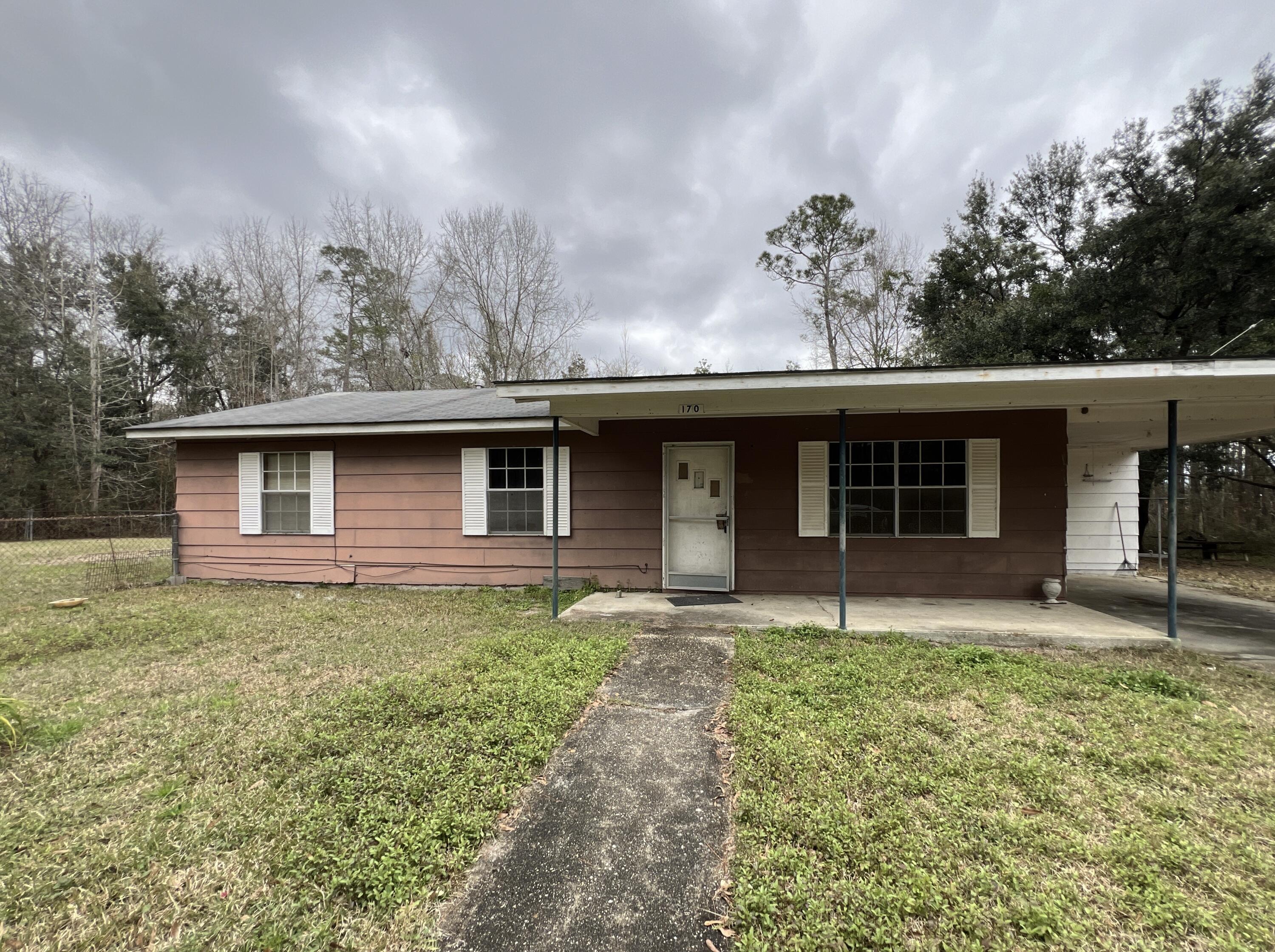 Located in the heart of Century, this 3bed 1.5 bath REO home screams sweat equity. Originally but in 1972, this home is 1118sf and comes with 1 acre, which is nearly fully fenced with chain link fencing. Home has masonite and wood siding, an attached carport, an attached laundry/storage area. There are several detached storage buildings as well. Home will not qualify for most financing due to repairs needed, however, there are certainly finance options possibly available for owner occupants.