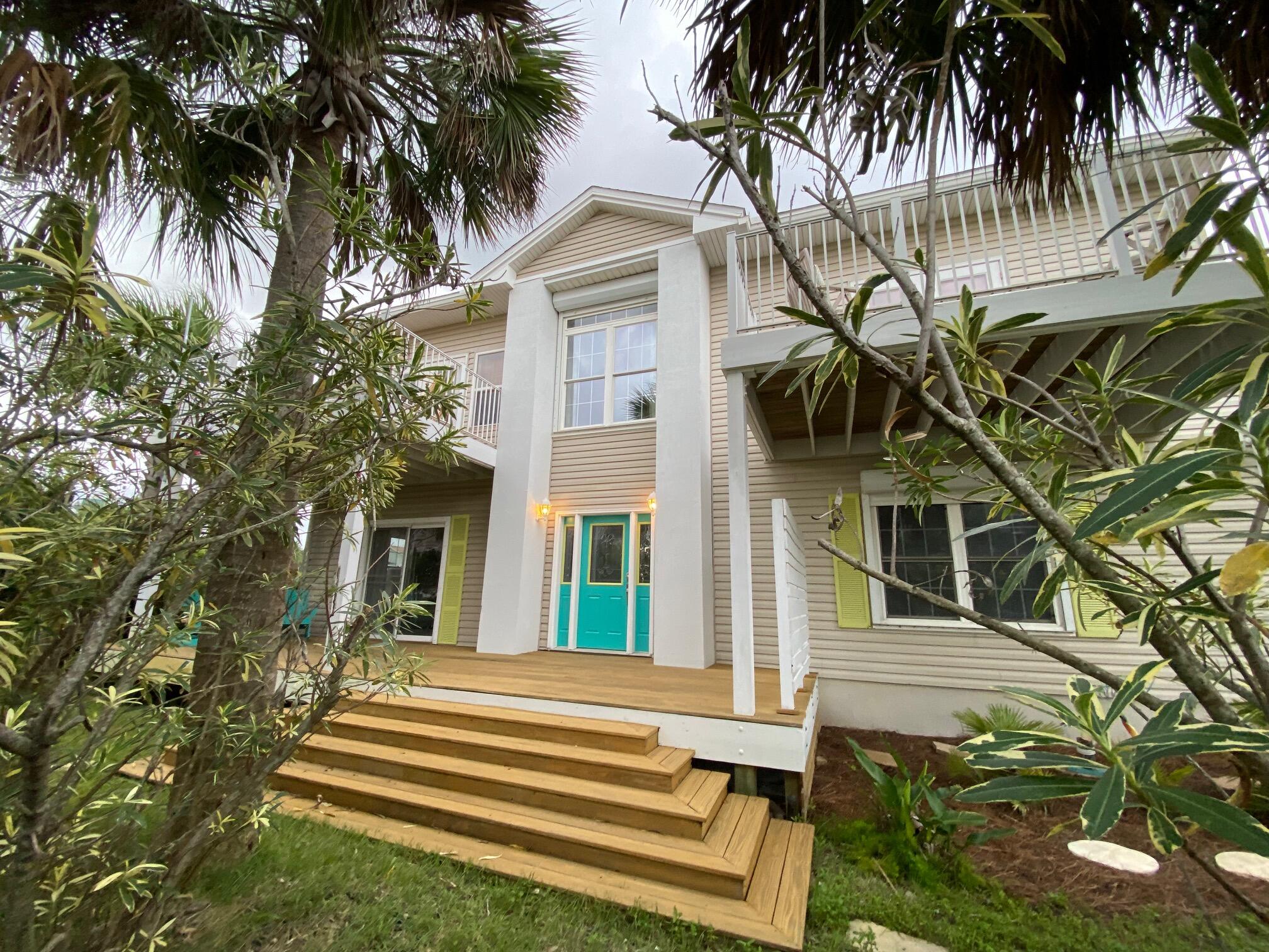 Experience the ultimate coastal lifestyle on Okaloosa Island in this fully updated 3,000+ sq. ft. 3BR/3BA Coastal Colonial, offering rare views of both the Gulf of Mexico and the Intercoastal Waterway. Located on a Beach Way, you are just 40 steps from sugar-white sand in one direction and a paddleboard/kayak launch in the other. This stunning home sits on one of the island's largest corner lots (0.39 acres) and features a new roof, new HVAC, 1,527 sq. ft. of freshly stained decking, lush tropical landscaping providing privacy, and a lap pool for year-round enjoyment. Inside, you'll find a flexible layout with multiple living spaces, French doors off living area let the sunshine in, a spa-inspired primary suite with two walk-in closets, a gas fireplace, updated kitchen with Hermosa Gold Quartz counters, and two skylit bonus rooms ideal for guests, hobbies, plus a detached home office.
Five decks (upper and lower) capture Gulf breezes and spectacular views, perfect for entertaining or relaxing after a day at the beach. Stroll or bike to dining, shopping, the fishing pier, waterfront parks, and the Boardwalk, or simply watch fireworks from your private balcony. With nearby A+ schools, vibrant cultural arts, and rising property values fueled by local redevelopment, this exceptional home is both a lifestyle and an investment.
Select artwork and furniture negotiable.
Make this stunning must-see coastal home with privacy galore yours. Too many unique features to list. Call to tour today!