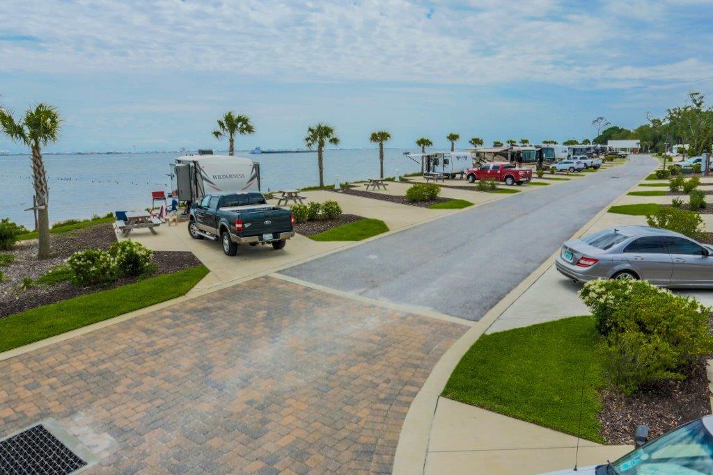 Newly developed in 2012, the St. Rosa Sound RV Resort enjoys an exceptional, high visibility site on 1000+ pristine feet along the scenic Santa Rosa Sound and is centrally located in the popular resort destination of Navarre, Florida, approximately 23 miles to the west of Destin, Florida, and 25 miles to the east of Pensacola, Florida. The superb logistics from Interstate 10 via Highway 87 cater perfectly to the growing RV vacation audience in search of premier destinations, specifically motor-coach and fifth-wheel owners. The resort features a host of marketable amenities and is currently managed by InnisFree Outdoor Hospitality. Navarre Beach is approximately one mile away, and many commercial conveniences, including a Publix Supermarket, are immediately surrounding the resort.