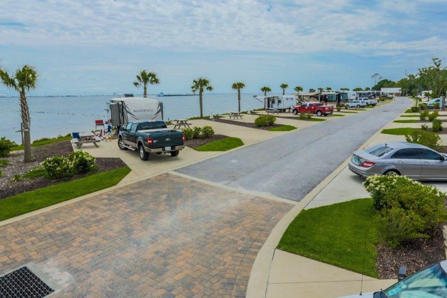 Newly developed in 2012, the St. Rosa Sound RV Resort enjoys an exceptional, high visibility site on 1000+ pristine feet along the scenic Santa Rosa Sound and is centrally located in the popular resort destination of Navarre, Florida, approximately 23 miles to the west of Destin, Florida, and 25 miles to the east of Pensacola, Florida. The superb logistics from Interstate 10 via Highway 87 cater perfectly to the growing RV vacation audience in search of premier destinations, specifically motor-coach and fifth-wheel owners. The resort features a host of marketable amenities and is currently managed by InnisFree Outdoor Hospitality. Navarre Beach is approximately one mile away, and many commercial conveniences, including a Publix Supermarket, are immediately surrounding the resort.