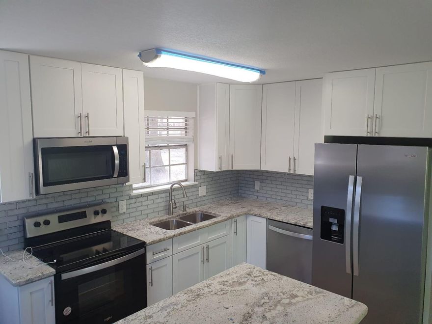 Remodeled home with many upgrades. Upgrades include new kitchen cabinets, lighting, granite counter tops and Stainless Steel Appliances.  New Copper wiring, new interior paint, New lighting and ceiling fans throughout the home, new laminate flooring in living areas and carpeting in bedrooms. Home also has a metal roof.,