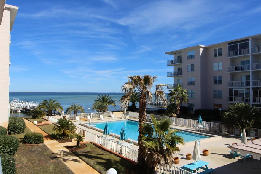 ENJOY SERENE BAYFRONT LIVING IN THE HEART OF DESTIN! This immaculate move-in-ready unit has new flooring throughout. Open living area leads out to a sizable balcony with views of the Choctawhatchee Bay and the immaculate parklike grounds of the community. Spacious master suite has private access to the balcony. In addition to the owner's closet outside the unit, there is a large storage closet inside the unit for added convenience. Century Park West is the best kept secret in town. Amenities include pool, community dock, picnic area, fishing station, assigned parking, and on-site HOA. Don't miss this one! Call today!