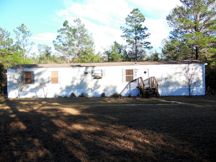 So affordable, this 2 bedroom, 2 bath single wide 2007 mobile home 14x66' on 1 acre, fenced, deep well, new central A/C only 2 months old.Home is fairly secluded yet in walking distance of the General Dollar Store in Mossy Head. Home comes furnished with master bedroom suite, TV, dining room suite, washer and dryer, refrigerator, stove and dishwasher. This is a great location for workers at Eglin, Crestview and Niceville...within 4 miles of I-10 Exit.