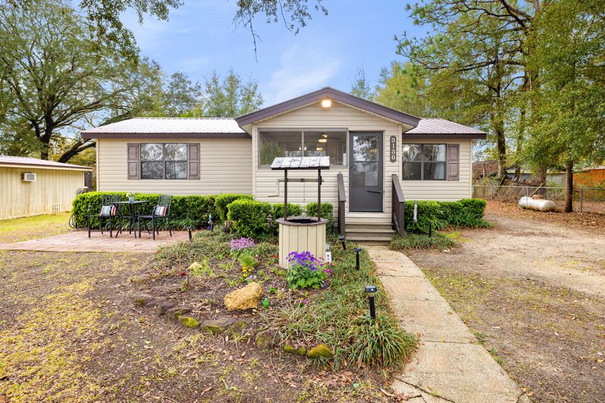 Discover the perfect blend of country charm and modern convenience in this 4-bedroom, 2-bath home located in southeast Crestview.Nestled on a 'country road' street but just 2 miles from town, this 1,280 sq. ft. home is conveniently located. The fully fenced yard offers plenty of space including a well-equipped finished shed. Need space for your hobbies or storage? You'll love the powered workshop and detached carport--large enough to fit an RV!Inside, enjoy two separate living spaces, a screened porch, and a tiled bathroom. The owner suite is tucked off the living room and features a private half bath with a washer/dryer hookup. The home is well-maintained with major updates, including a metal roof, new HVAC (2019), and updated plumbing and electrical (2014). Plus, a mini-split system for the home addition, and a tankless gas water heater ensures endless hot water. Need backup power? The home is already wired for a generator hookup!