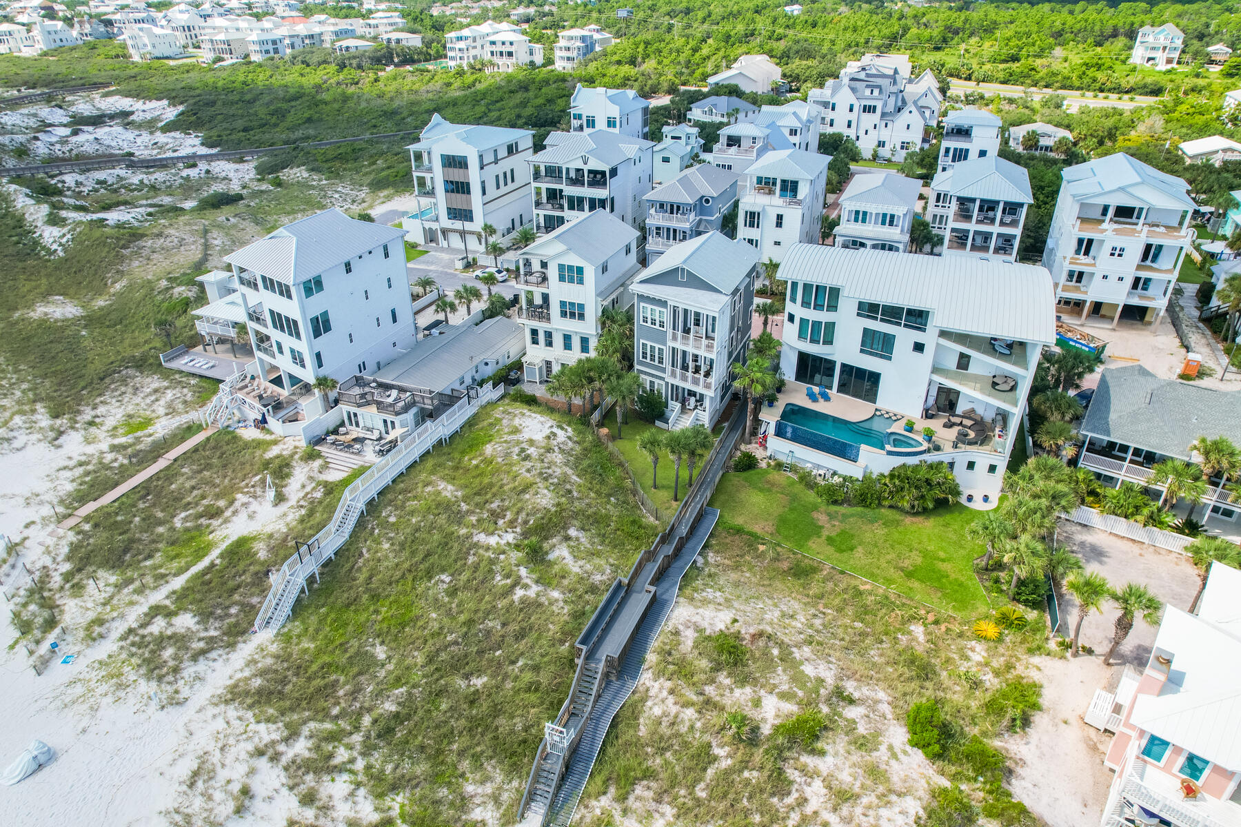 Welcome to your dream beach home at 93 Emerald Cove Lane, located steps away from the Gulf of Mexico in Inlet Beach, Florida.Situated south of Highway 98 perfectly located between Panama City Beach and 30A, this stunning 5-bedroom, 3.5-bathroom property offers the perfect blend of luxury and coastal living. The main living area is on the third floor, accessible by elevator or stairs, and boasts an expansive balcony with breathtaking Gulf views. The balcony was reconstructed in 2021, and the entire home was renovated in 2020. Imagine cooking your favorite meal with your favorite song on, enjoying the shimmer from the serene blue waters - truly breathtaking. With a robust rental history and promising future projections of up to $130,000 annually, this home is not only a serene retreat but also a smart investment. The third floor includes one bedroom, a separate sitting room, and a powder bath. The second floor features three bedrooms and a full bath, including the master bedroom with an en-suite bathroom. The first floor offers an additional bedroom with a full bathroom.

This home has everything you need for a relaxing beach lifestyle.