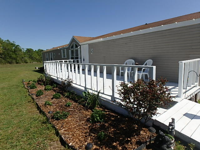 Do you like quiet? Do you want room to roam? Then this property is for you. 10 acres of cleared land, with a 3 bedroom 2 bath updated mobile home. The inviting living room greets you as you enter the home and the open floor plan is perfect for entertaining. The laundry room is hidden behind the pantry doors, and there's room for additional storage shelves or a 2nd refrigerator. The split floor plan has the master suite features vaulted ceiling, garden tub, separate shower and walk-in closet. Relax on your over-sized front deck and watch the deer as they snack in your yard. Buyer to verify room dimensions.