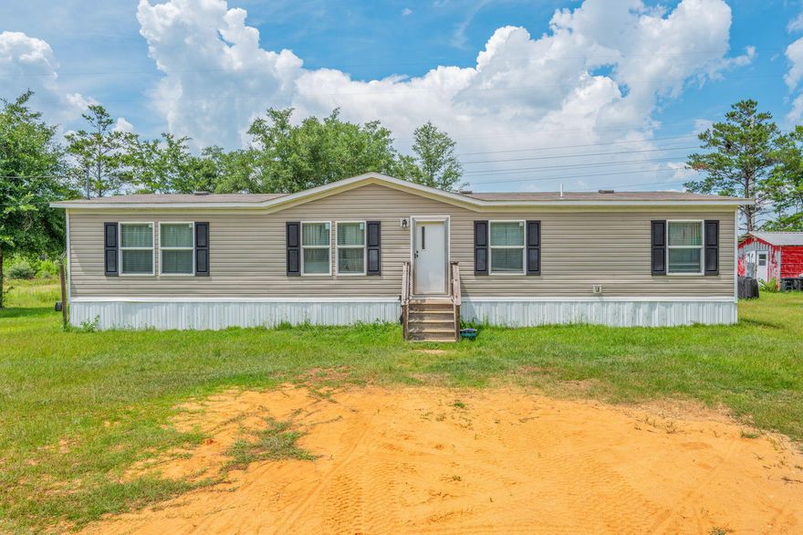 Don't miss your chance to own this beautiful home--set on two lots totaling over half an acre! This top-of-the-line 4 bedroom, 2 bath home offers 1,475 square feet of well-designed living space. The open-concept floor plan features a split layout for added privacy, durable vinyl laminate flooring throughout, a spacious kitchen island, patio doors leading to the backyard, and custom shelving in the utility room. Built with high-quality materials and energy-efficient standards, this home is as practical as it is beautiful. Located just off a paved road with public water and a septic tank, it offers the perfect mix of comfort and convenience.Only 30 minutes from Crestview, DeFuniak Springs, and several military bases--this one won't last long.