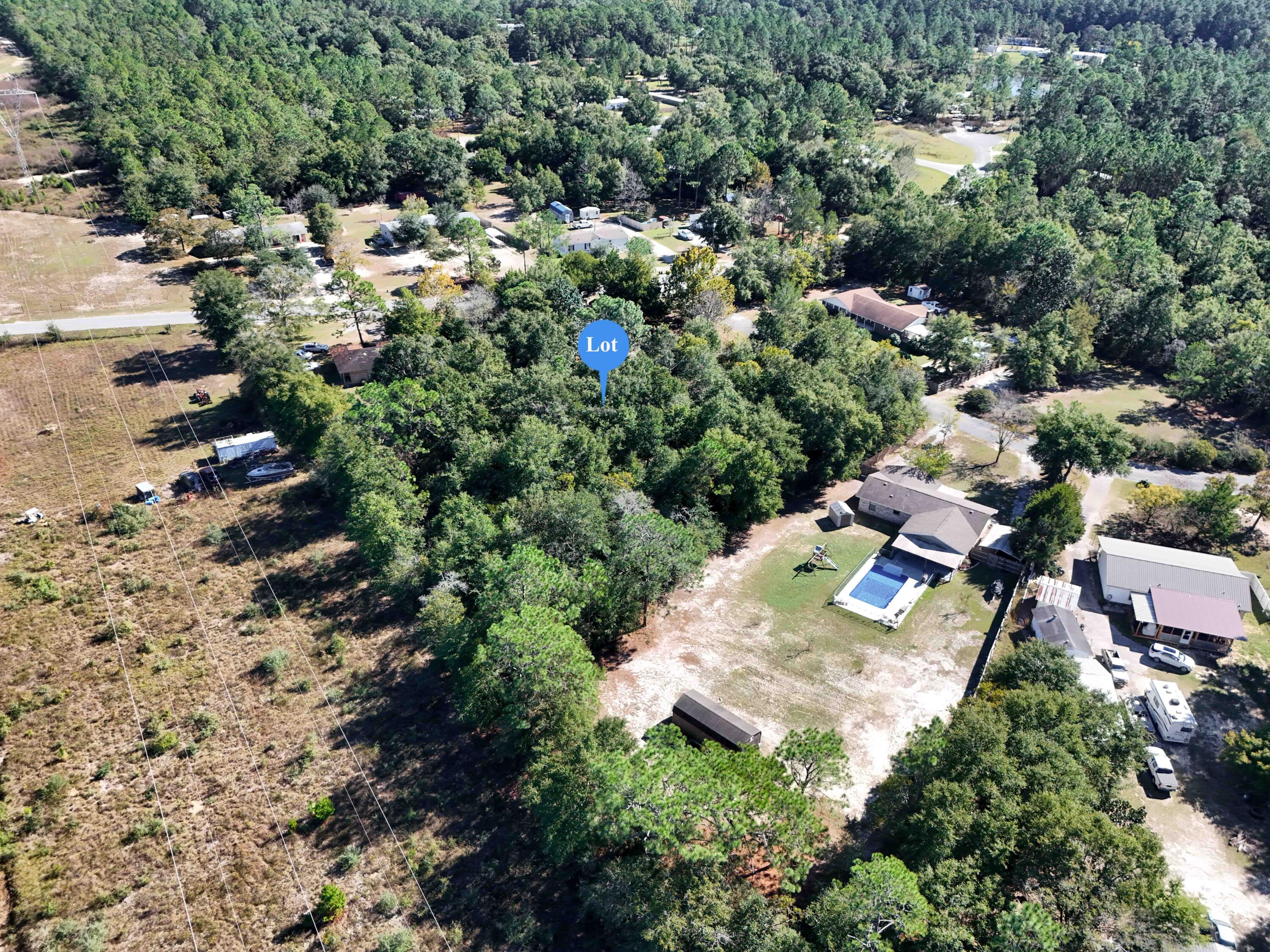 This is a beautiful, level, building site that's right under 1 Acre just outside the city limits of, and a quick 5 minutes drive to, downtown DeFuniak Springs, FL. With street access to electric and city water (tap unpaid), it will require a septic upon building. It appears the community covenants and restrictions have expired and manufactured homes would be allowed, though the street only contains site built at this time. Pls verify anything of importance prior to making an offer. BUILDERS: THREE other lots available in the same block (1/2 acre +) and seller would make a package deal for all!
