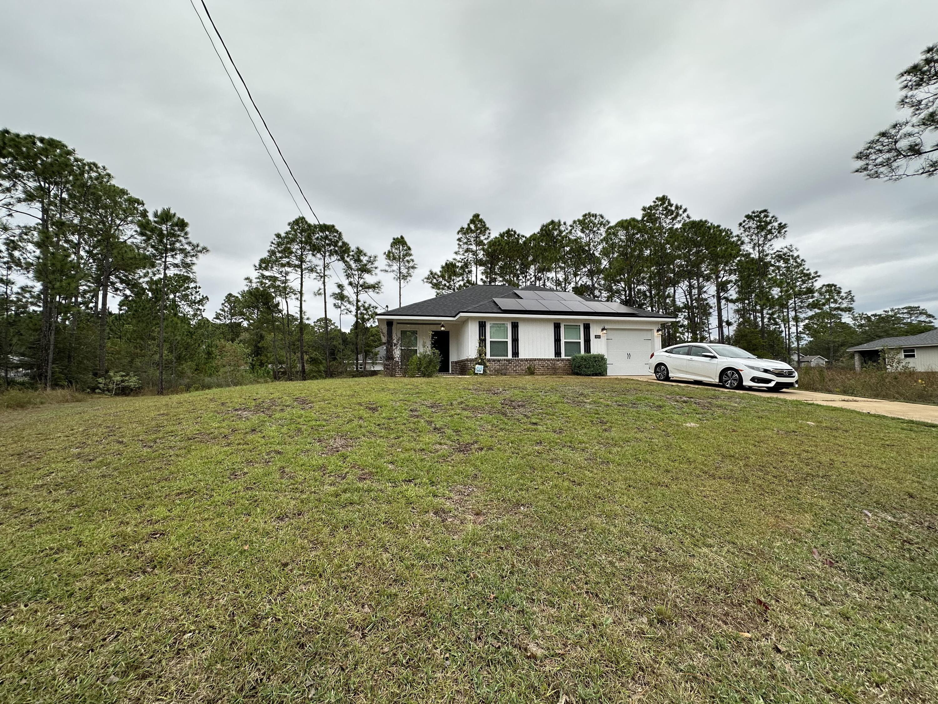 Beautifully maintained 2020-built Craftsman-style home located in the heart of Gulf Breeze. This residence perfectly blends modern comfort, energy efficiency, and timeless design all within one of the area's most desirable communities.From the moment you arrive, the home's inviting curb appeal and well-kept landscaping set the tone for what's inside. Step through the front door into a bright and open living space highlighted by a striking tray ceiling that adds height and character. The seamless flow between the living, dining, and kitchen areas creates an airy, comfortable layout ideal for both everyday living and entertaining. The kitchen is a true showpiece perfectly situated in tandem with the living room to help blend the everyday family lifestyle and hosting into one. With 36-inch upper cabinets, soft-close dovetail drawers, sleek black and stainless appliances, and ample counter space for meal prep or casual dining. Whether you're cooking for the family or hosting guests, this kitchen delivers both function and style.
The master suite offers a peaceful retreat at the end of the day, complete with its own elegant tray ceiling and a generous walk-in closet. The ensuite bathroom combines modern luxury with practicality, featuring a double vanity, a garden tub with shower, and high-end finishes throughout. Two additional bedrooms provide flexibility for a growing family, guests, or a home office.
Outside, the expansive 0.27-acre lot gives you room to enjoy Florida's outdoor lifestyle. There's plenty of space for barbecues, play areas, or even adding a pool in the future all while maintaining an easy-to-care-for yard. The quiet cul-de-sac location provides privacy and a safe environment for families, while still being just minutes from schools, beaches, restaurants and more.
This Home offers the perfect combination of style, comfort, and function in a home that feels brand new. Whether you're a first-time buyer, a growing family, or looking to downsize into something modern and manageable, this Gulf Breeze gem checks every box.