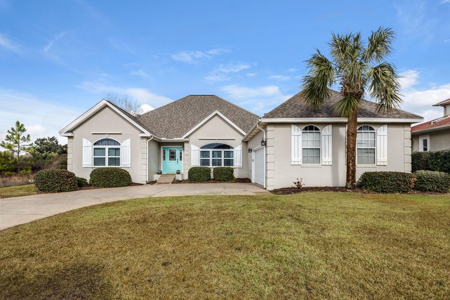 PURA VIDA! Make this delightful Florida pool home yours today! With partial views of the Santa Rosa Sound (Intercoastal Waterway), your own private swimming pool and backyard oasis with palms and lush landscaping, private community beach access, and an open and inviting 1-level floor plan, this home has it ALL!This is a custom-built, easy-to-maintain home with tall ceilings and expansive windows that take advantage of the partial Sound views to the front of the property. Upon entering the home, beautiful dark ''Maple Castillo'' quality laminate wood-look flooring makes a statement in the Great Room, complemented by Castillo Mexican tile in Kitchen and Foyer area.