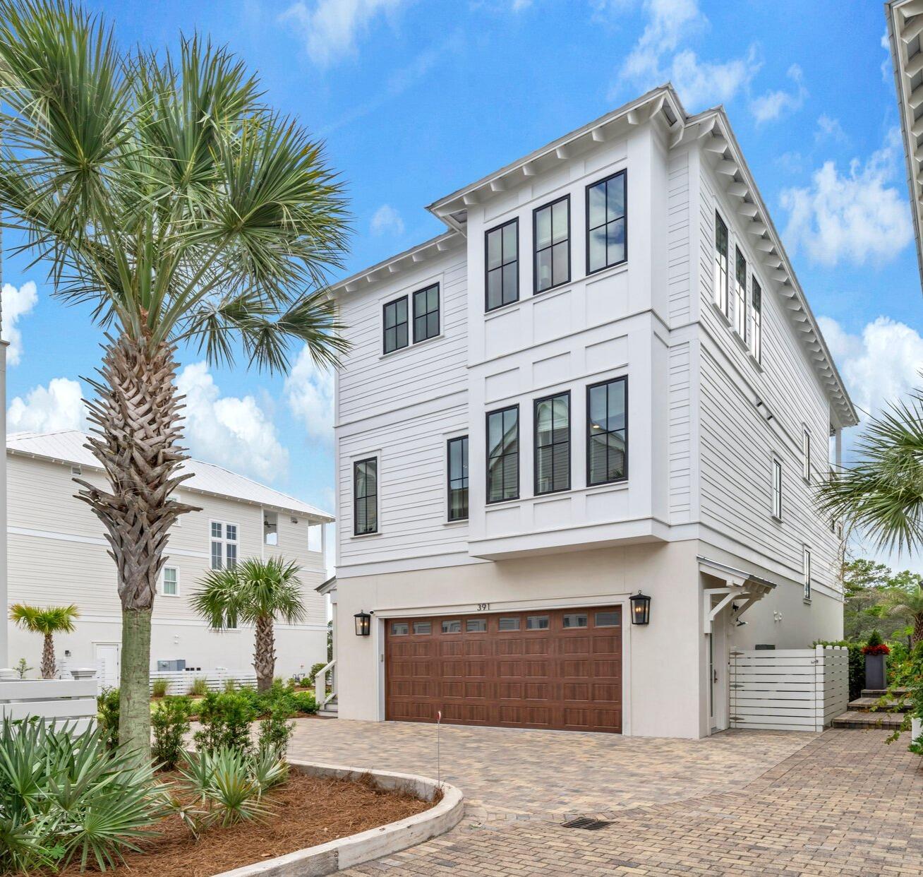 Looking for a home with Gulf views and surrounded by nature? This is it!This stunning, fully furnished 5-bedroom, 4.5-bathroom home is perfectly positioned on the West end of 30A, backing up to the untouched Topsail Hill State Park and Preserve. Offering a rare blend of Gulf views and natural privacy, this thoughtfully designed 3-story coastal retreat is built for both comfort and style.Enter through a covered walkway to the first floor, where you'll find two spacious guest bedrooms, a shared bathroom with double vanity, and a large under-stair storage closet--perfect for beach gear or seasonal storage. A 2-car garage adds extra convenience.Head upstairs via stairs or elevator to the second floor, where the master suite overlooks the serene pines of the preserve. This suite features a large walk-in closet and a spa-style bathroom with a soaking tub, separate shower, and dual vanities. Also on this floor is a laundry room with custom floor-to-ceiling cabinetry and two additional bedrooms,one bedroom with an en suite bath and the other with its own private bathroom.
The third floor is an entertainer's dream: a bright, open space combining the living room, dining area, and kitchen. A custom fireplace adds warmth, while the dining space centers around a custom round table with a built-in lazy Susan, perfect for meals and game nights. The chef's kitchen features quartz countertops, custom cabinetry, GE Monogram appliances, a large island with seating, and a built-in coffee station.
Step out onto the third-floor balcony to grill, relax, and take in some of the most beautiful sunsets on the Gulf Coast. Back on the first floor, a charming flower garden and seating area provide another quiet space to unwind.
Located in the gated community of Cypress Dunes, you'll enjoy access to top-tier amenities:
Two resort-style pools, one with a Gulf views,
A luxury clubhouse with a chef's kitchen and large TV,
Fitness center, tennis and pickleball courts, outdoor fireplace, and a green space for kids and pets.
Scenic boardwalks and walking trails through century-old Cypress ponds and wildlife areas.
In summary: This beautifully maintained, designer furnished, move-in-ready 5-bedroom home offers a rare combination of coastal luxury, Gulf views, and natural beauty, making it the perfect retreat for families, vacationers, or those seeking full-time living in one of 30A's most peaceful and picturesque communities.