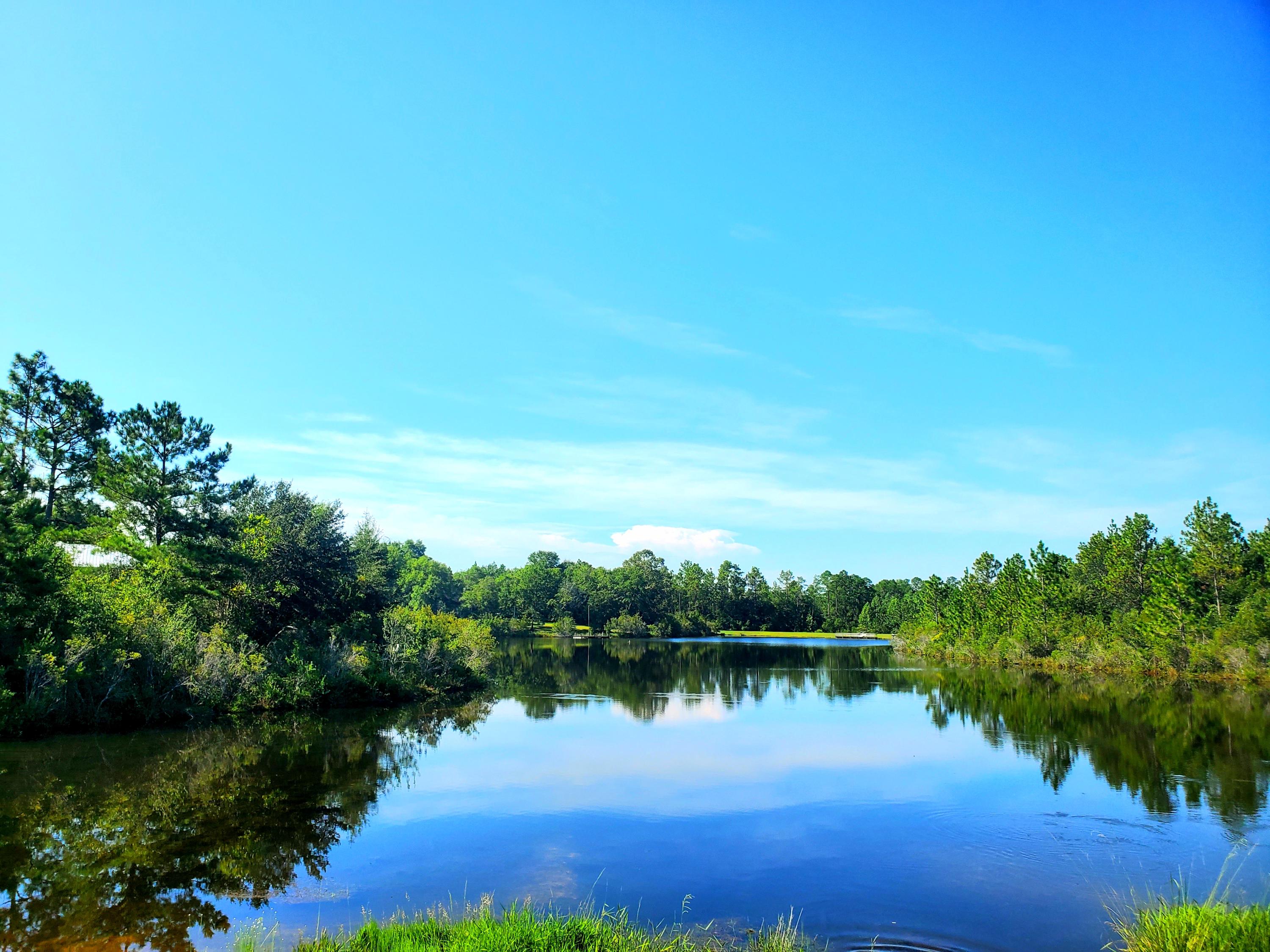 This water-front Lake Arthur Estates lot is ready to build your dream home. Located midway between Laurel Hill and the County Seat in Crestview, Lake Arthur is set back from the highway and offers the tranquility of country living with large common areas for exploring nature along with the conveniences and amenities of town life  schools, restaurants, post office, community center and public library, military bases, as well as shopping at Publix and Winn Dixie. Destin-Fort Walton Beach Airport and Emerald Coast beaches are less than an hour away  close enough to access when the need arises or the mood strikes, but far away from tourist traffic. A breath of fresh air, this is a perfect location to raise a family or relax on the lake in your retirement.