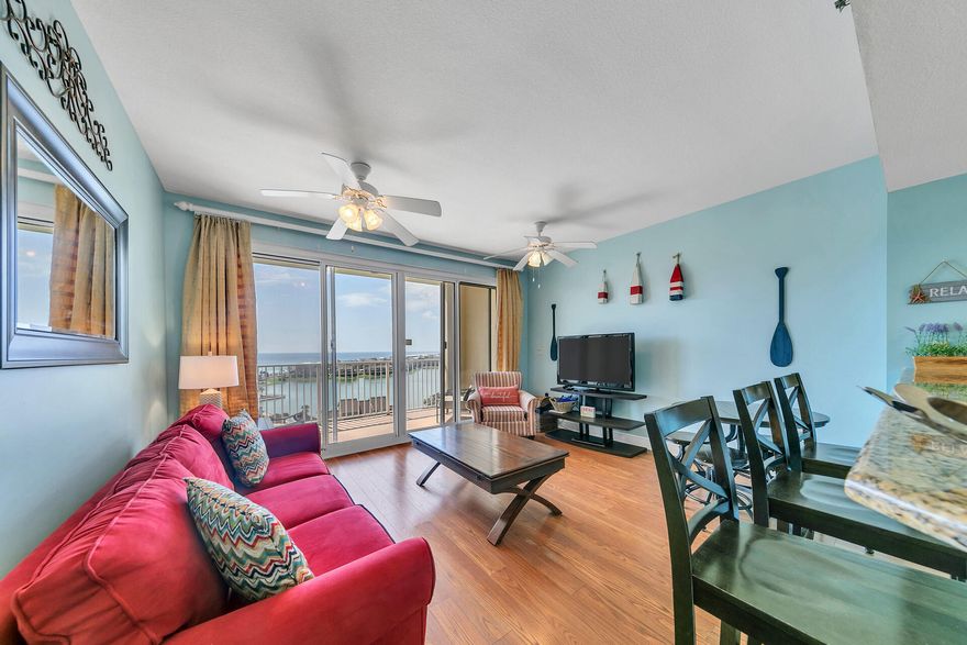 Incredible views of the Gulf and Stewart Lake can be enjoyed from the balcony of this one bedroom unit.  You will not want to miss the beautiful sunsets.  With the open floor plan, you can enjoy your family and friends while cooking.  This unit has a hallway built in bunk bed for additional sleeping.  The master bedroom has access to the full bath plus an adjoining half bath for your convenience. There is a stackable washer and dryer.  Right outside the door is a storage closet.  Ariel Dunes II has a large swimming pool and fitness center.  Seascape Resort offers a gated community, golf, tennis, pickle ball, a basketball court and additional swimming pools.  There is deeded beach access.  Enjoy the Whales Tail while at the beach!!  The Towne Centre offers restaurants and entertainment.